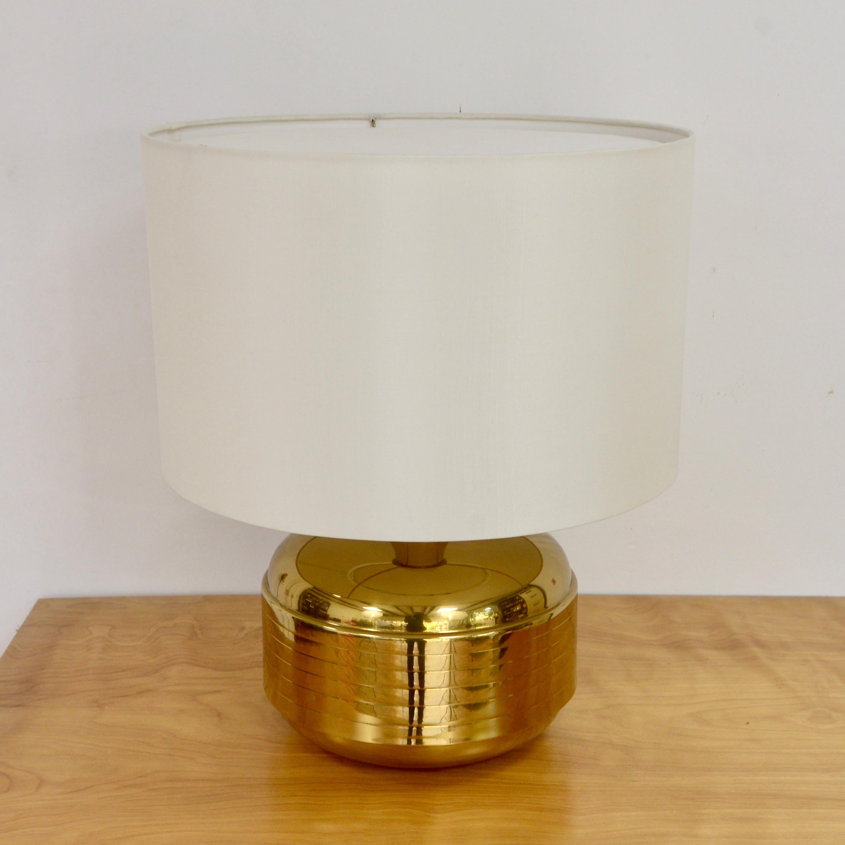 Fully restored 1960s brass Italian table lamp. Elegant and golden toned solid broad lamp base with a linear pattern. Rewired with a single E26 medium based socket, ready to be used in the USA. 
Measurements:
Height: 16”
Shade Diameter: 19”
Base