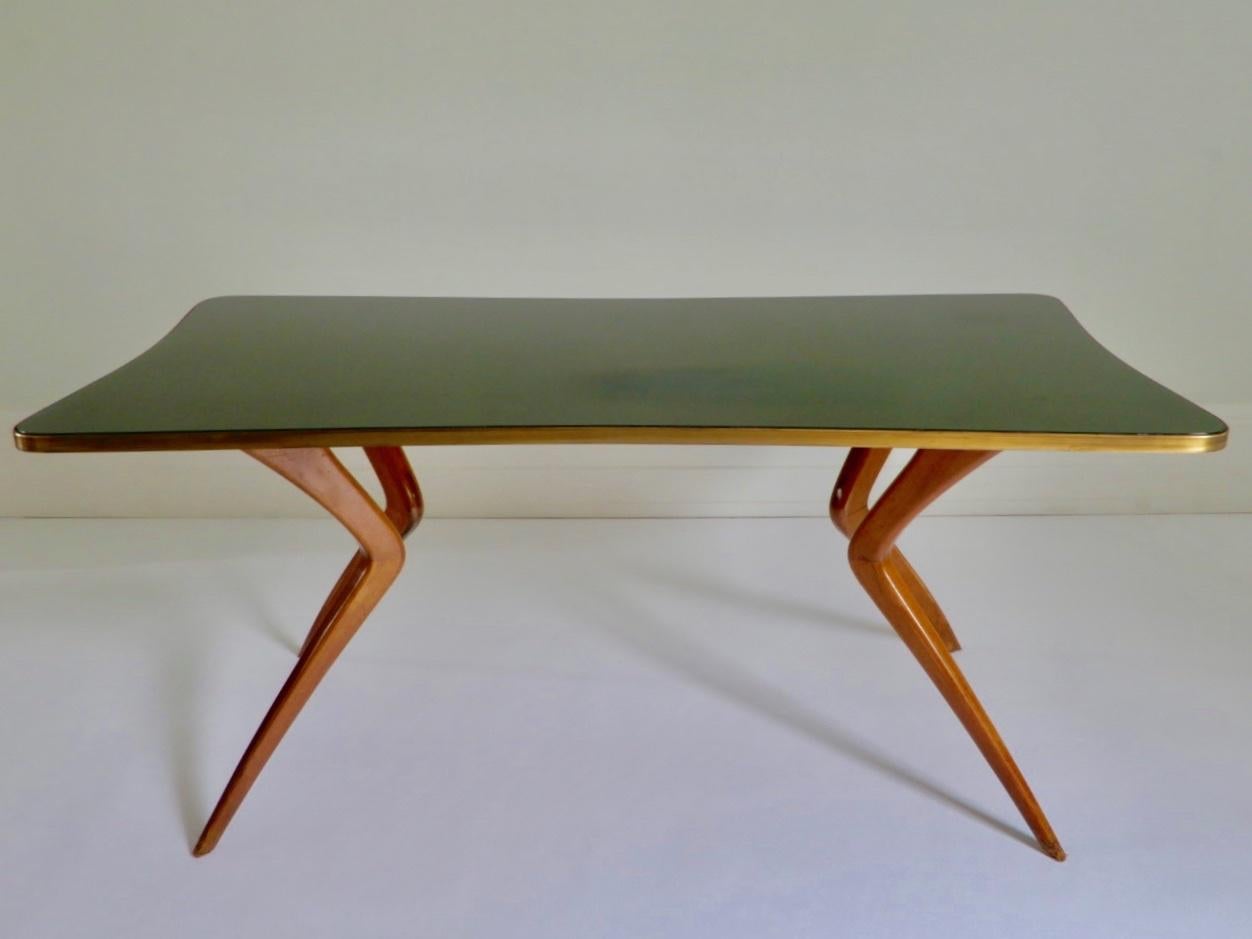 1960s Italian dining table or desk with wood legs and a green glass tabletop in the style of Ico Parisi. The glass top is original and in perfect condition.