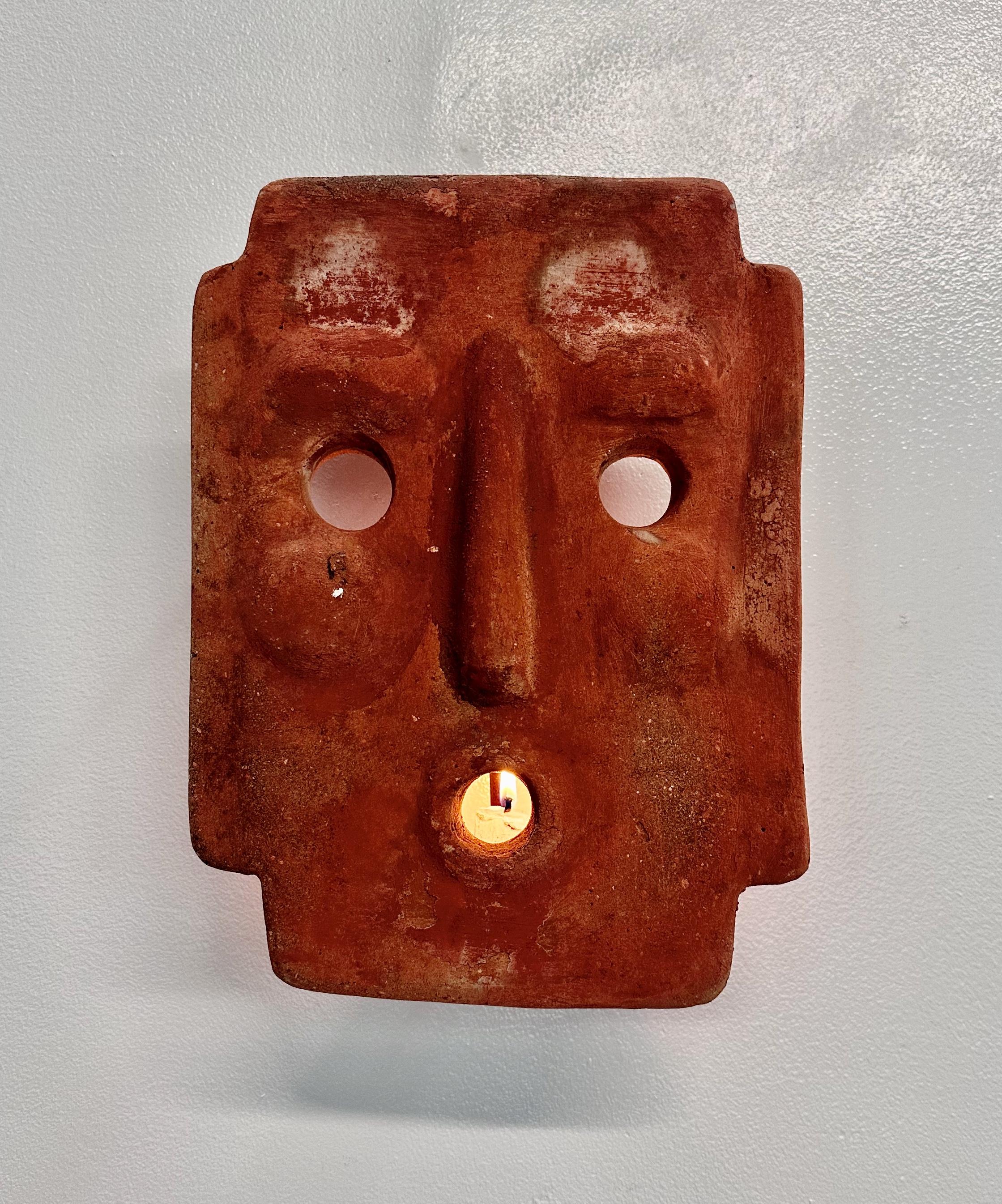 This handcrafted Italian Terracotta Mask Candle Sconce is a stunning addition to any outdoor space. Made with traditional terracotta clay and featuring a unique mask design, it brings a touch of Italian charm and authenticity to your home. The