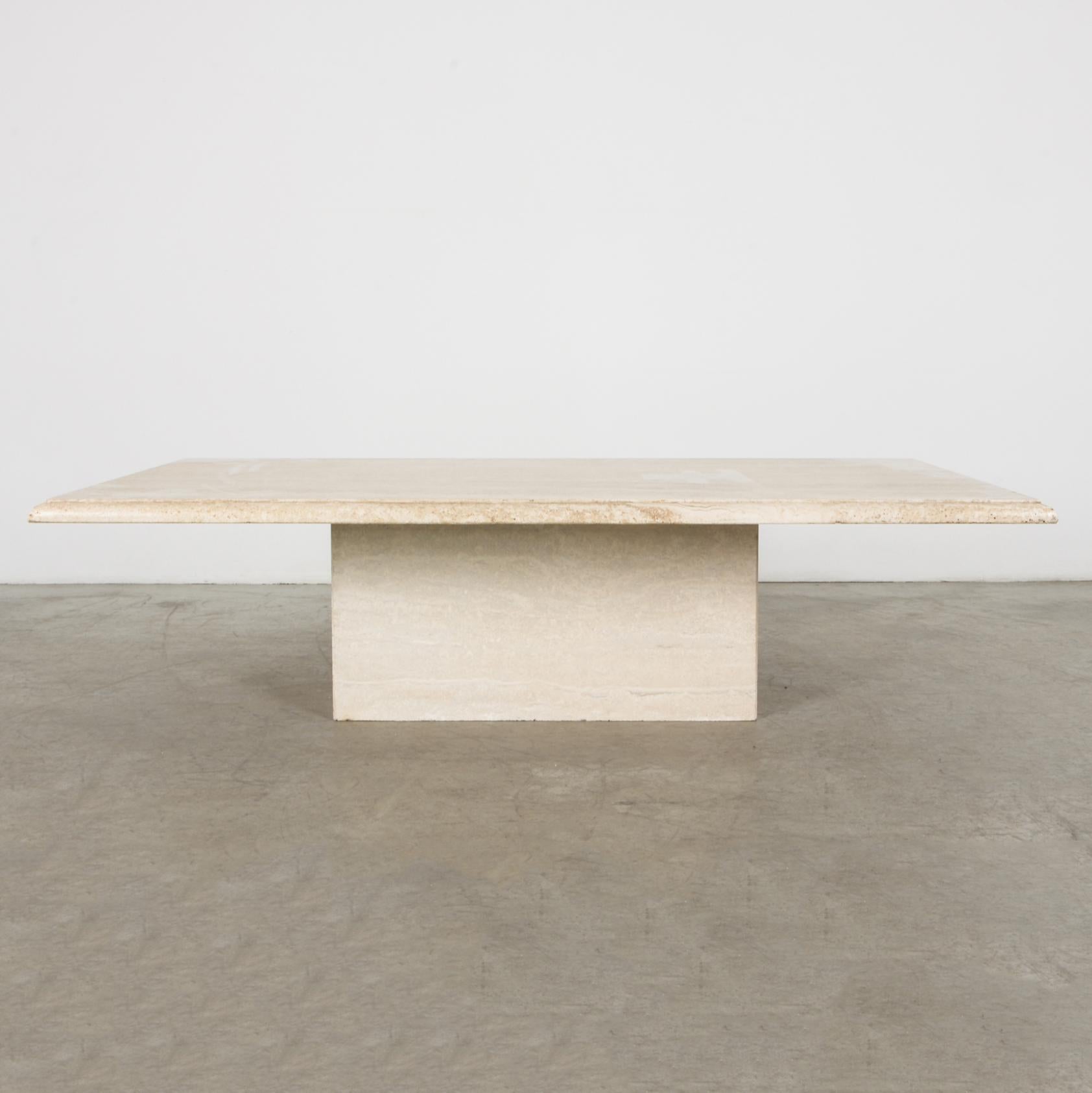 A cantilevered slab of textured travertine rests on a rectangular base in this stylish and simple coffee table. The tabletop is carved with dupont edge profile.

Stone is a material rich in itself. Echoing classical sculpture, a design that's sleek