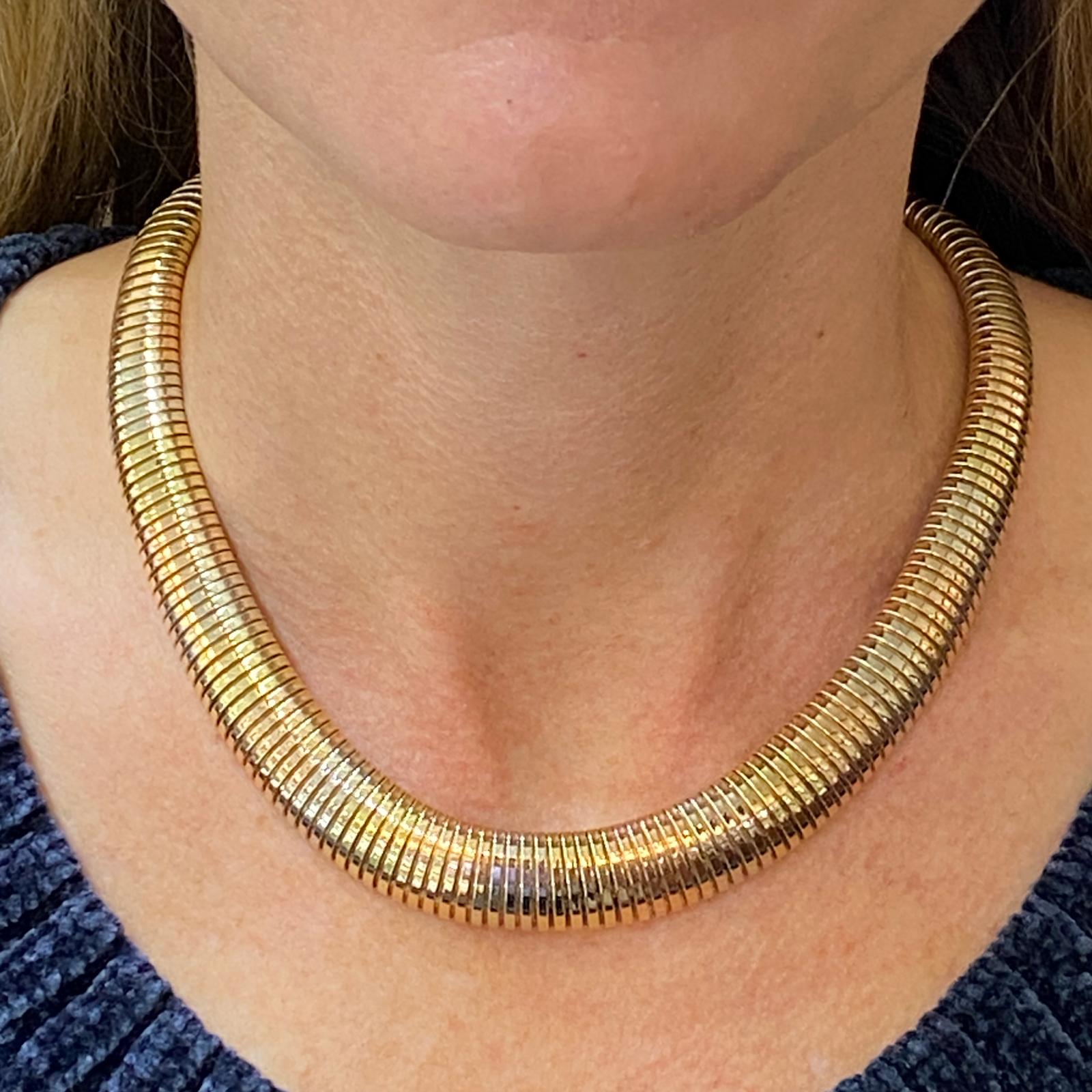 Beautiful 1960's graduated Tubegas necklace fashioned in 14 karat yellow, white, and rose gold. The Italian vintage necklace measures 16.5 inches in length and .30-.60 inches in width. Stamped Italy 585. 
