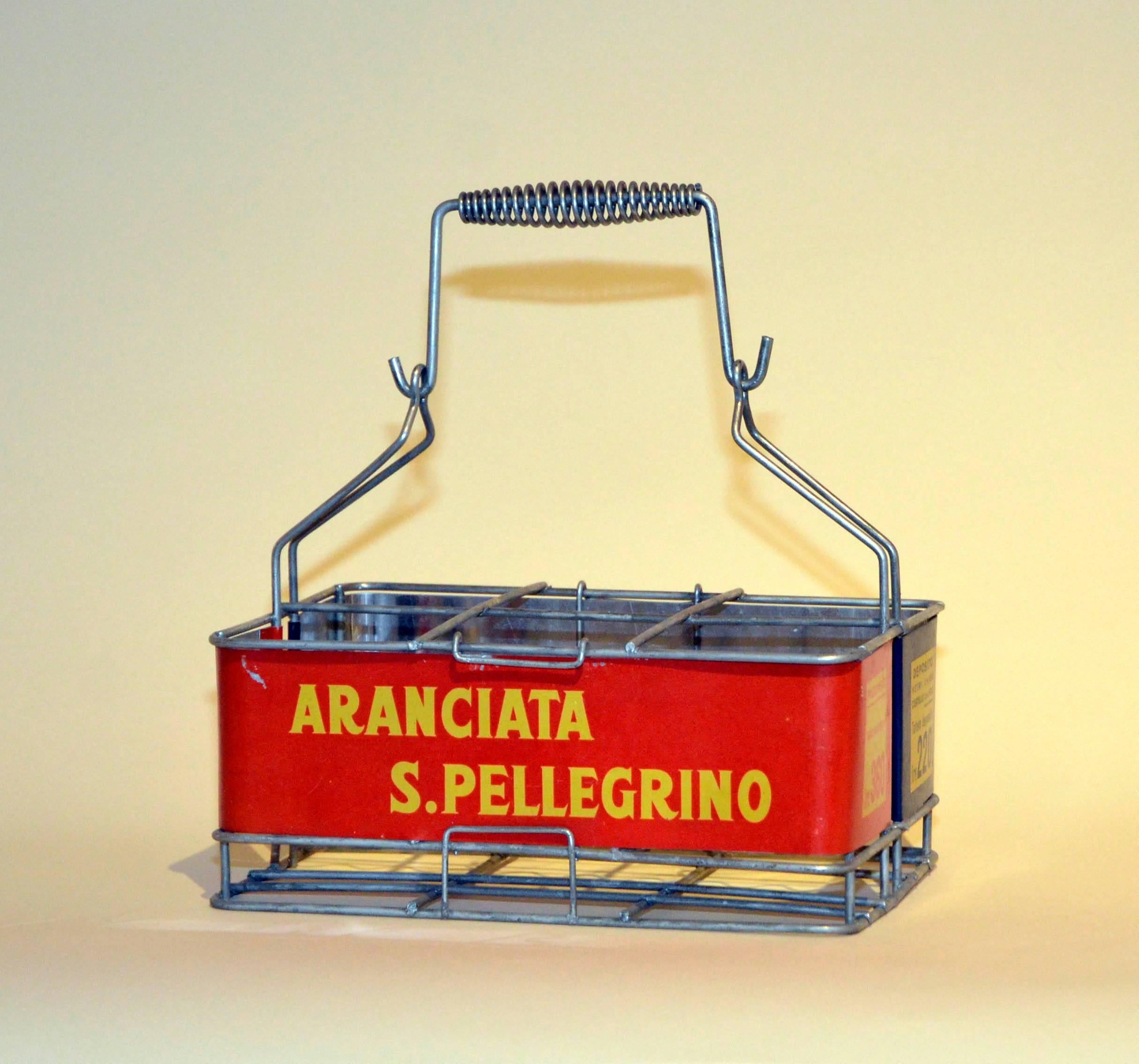 This very curious vintage metal San Pellegrino bottle basket, in red, yellow and blue, was used in the 1960s in Italy to deliver San Pellegrino's famed sodas, 