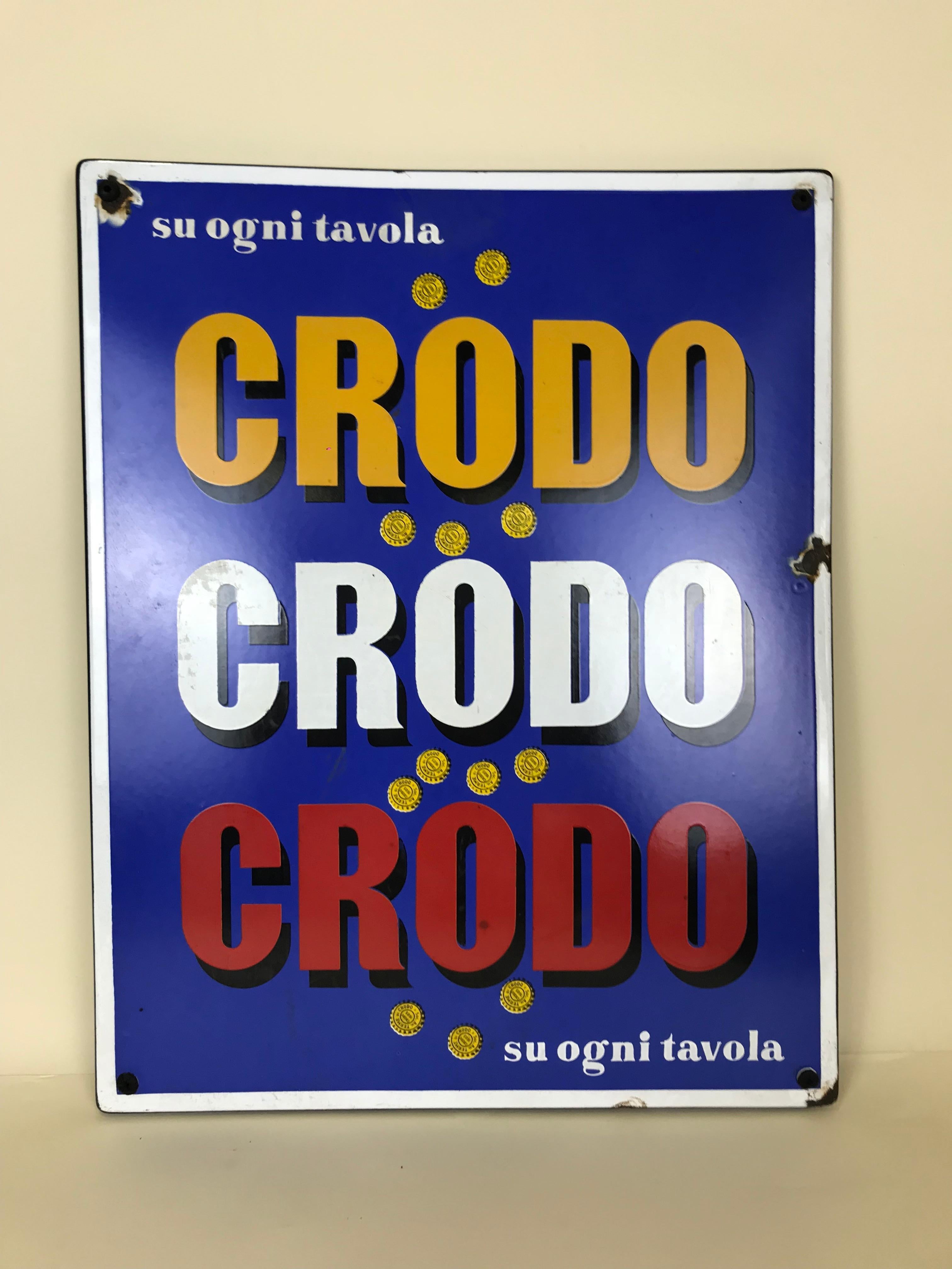 Vintage rectangular metal enamel mineral water Crodo sign produced for advertising purposes by Smalterie Lombarde in Italy in the 1960s.
Yellow, White and Red Crodo logo on blue background and slogan 