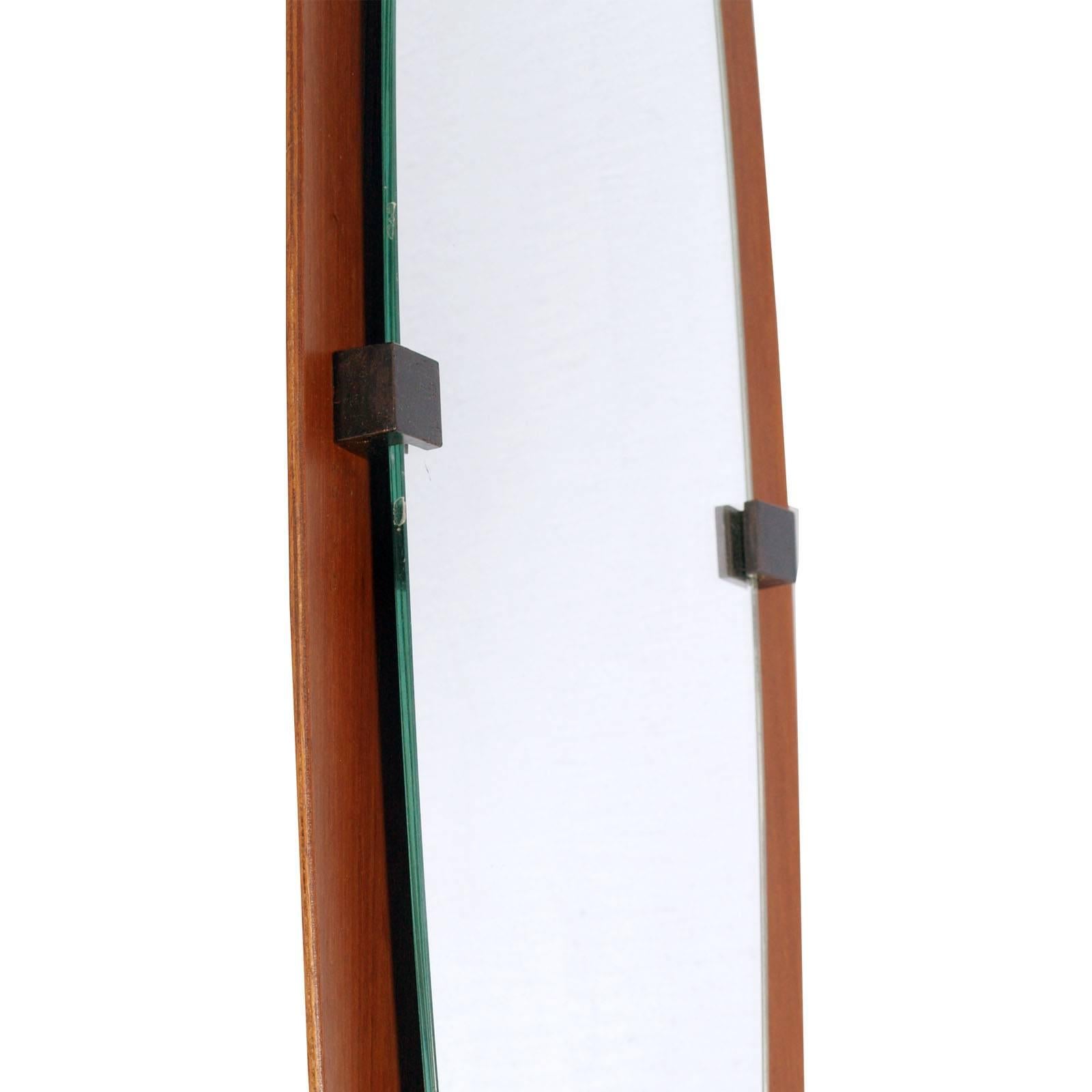 Italy oval mirror period, 1960s, by Franco Campo and Carlo Graffi for Home. Frame in bent plywood .
Measures cm: H 130 W 30 D 5 (mirror 98x23)

About Franco Campo and Carlo Graffi 
Franco Campo and Carlo Graffi, fellow university architects,