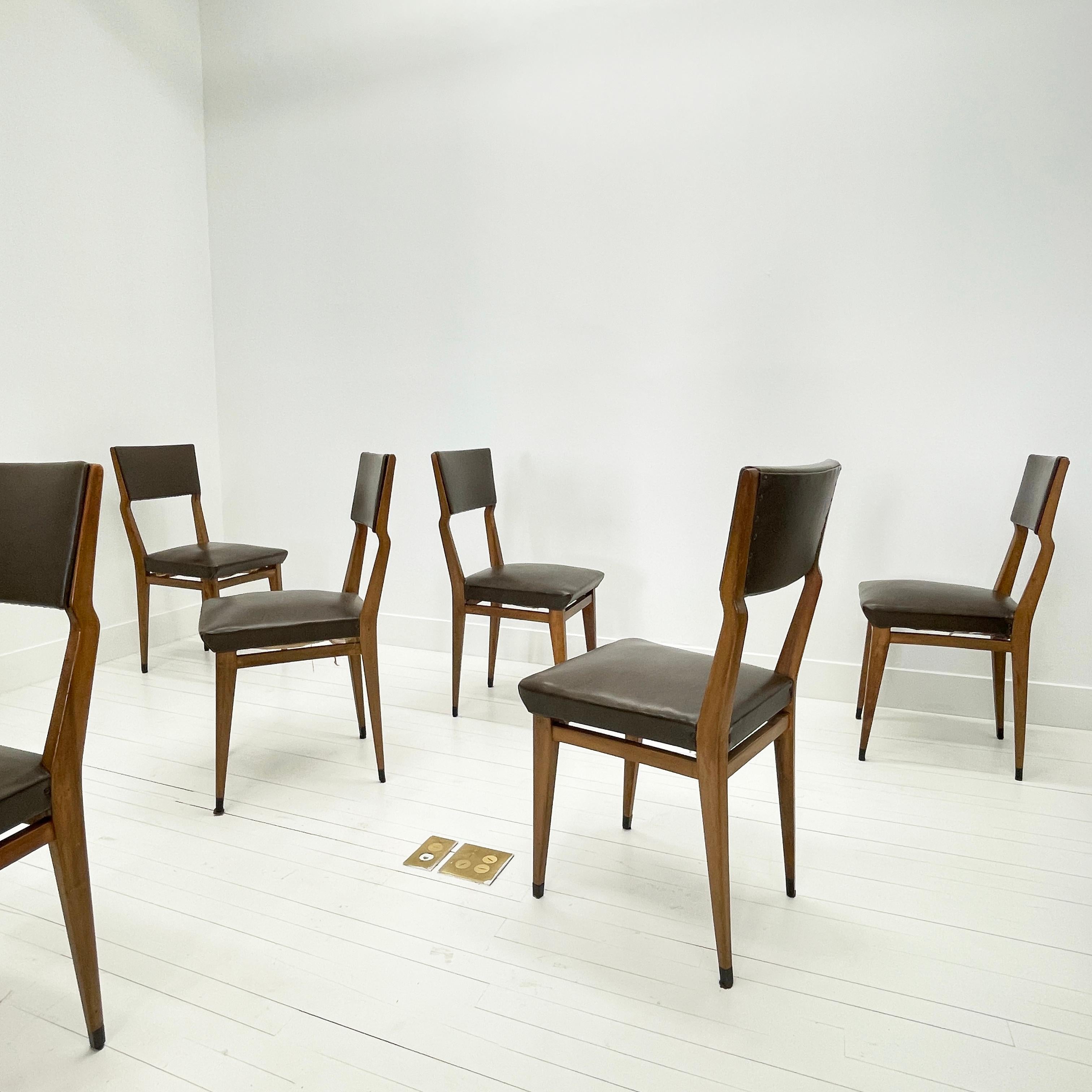 Set of 6 Walnut Dining Chairs, Italy, 1960's

This great looking set of refined, spare dining chairs have a distinctive carved offset detail to the frame. Their trim profile belies their sturdy nature -- Made of solid walnut with sprung seats and