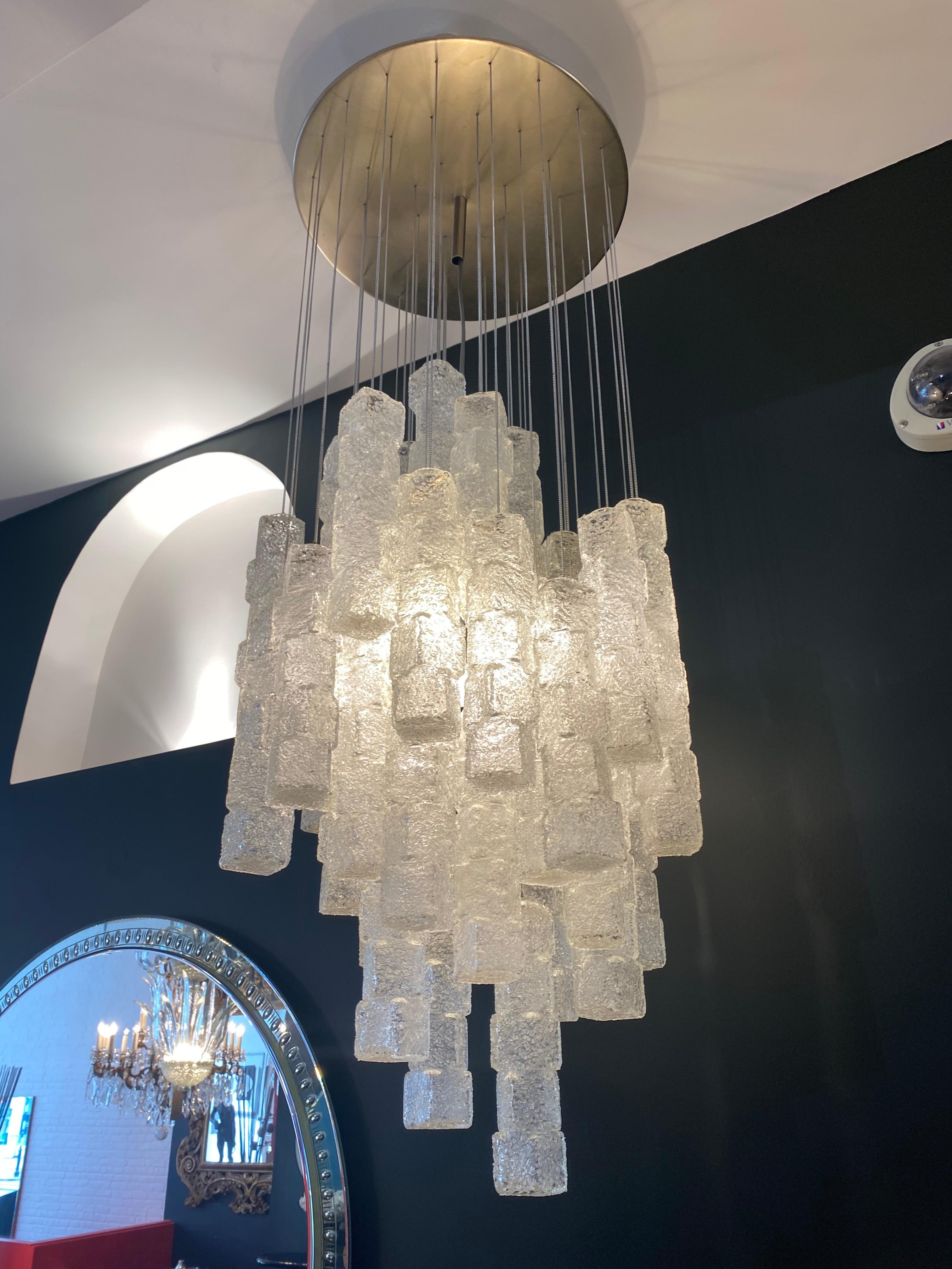 A rare Zero Quattro Milano chandelier made up of 42 frosted cube shaped glass suspended on chrome chains and supported by a circular metal structure with 4 lights.