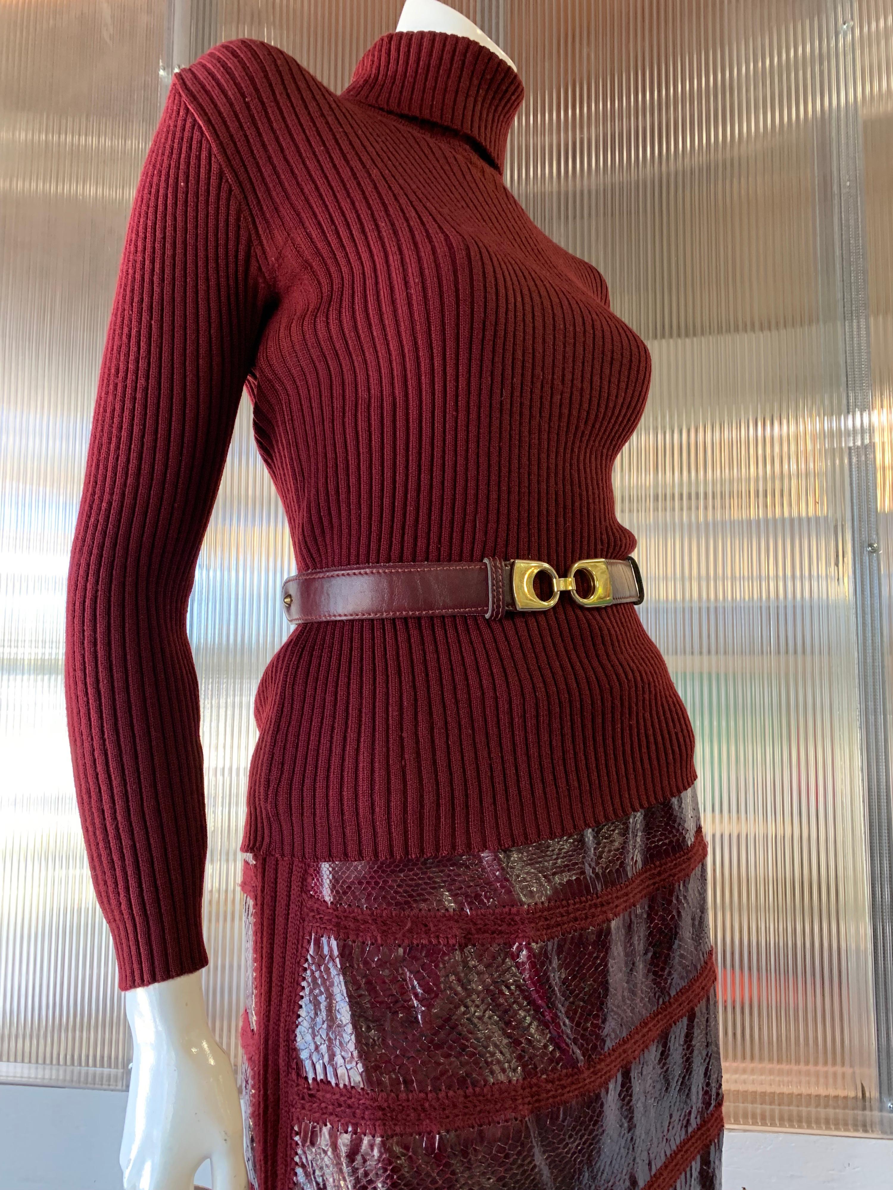 1960s J. Tiktinr 2-Piece Rib Knit Turtleneck Sweater & Snakeskin A-Line Skirt In Cranberry Color. Skirt is banded snakeskin joined by rows of knit. Lined skirt. Coordinating belt included.