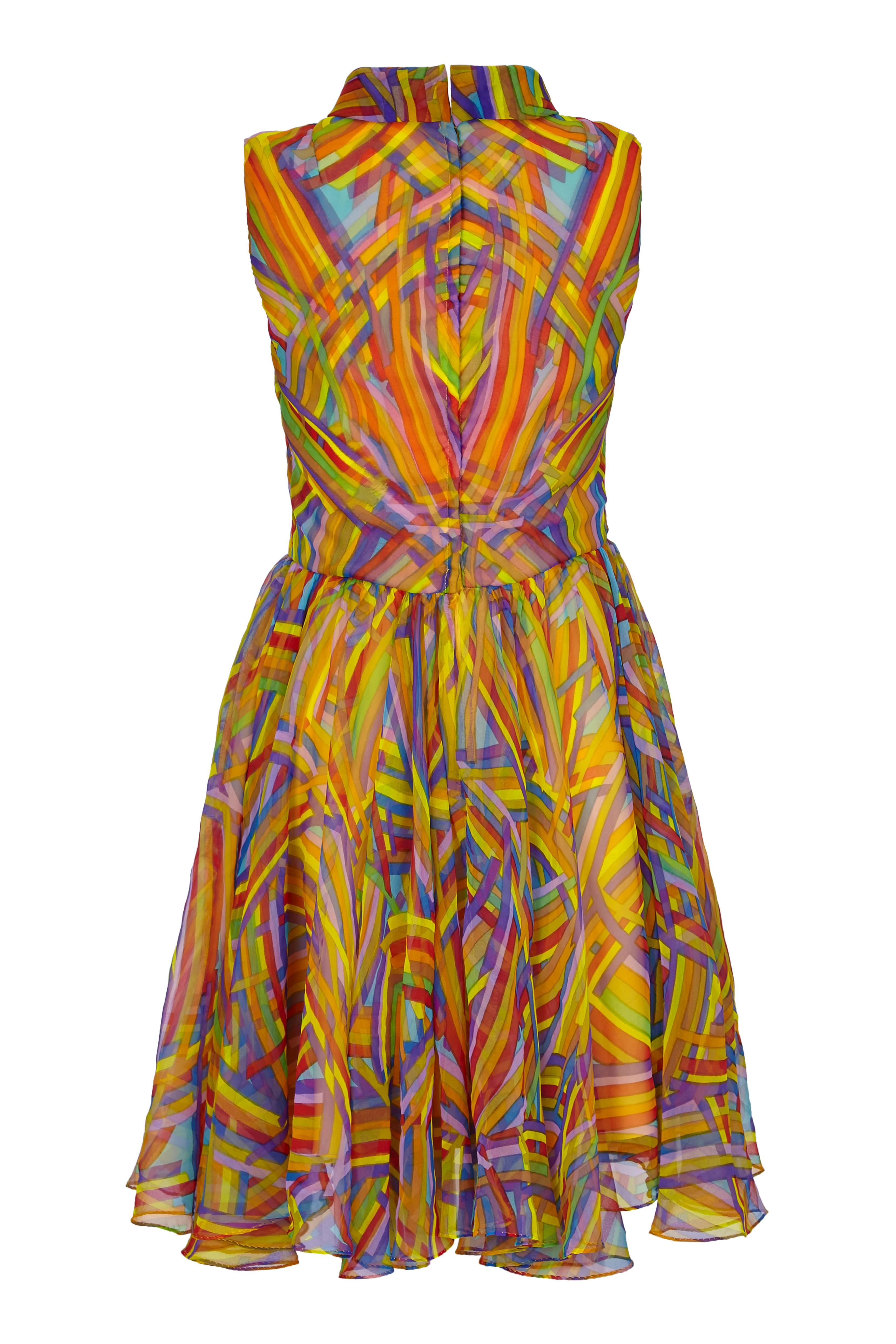This fantastic vintage 1960s Jack Bryan multi-coloured printed silk chiffon mini dress is playful, vivacious and in excellent vintage condition. The dress is a simple shift cut featuring a roll neck, gathered waistband and a full circle knee length