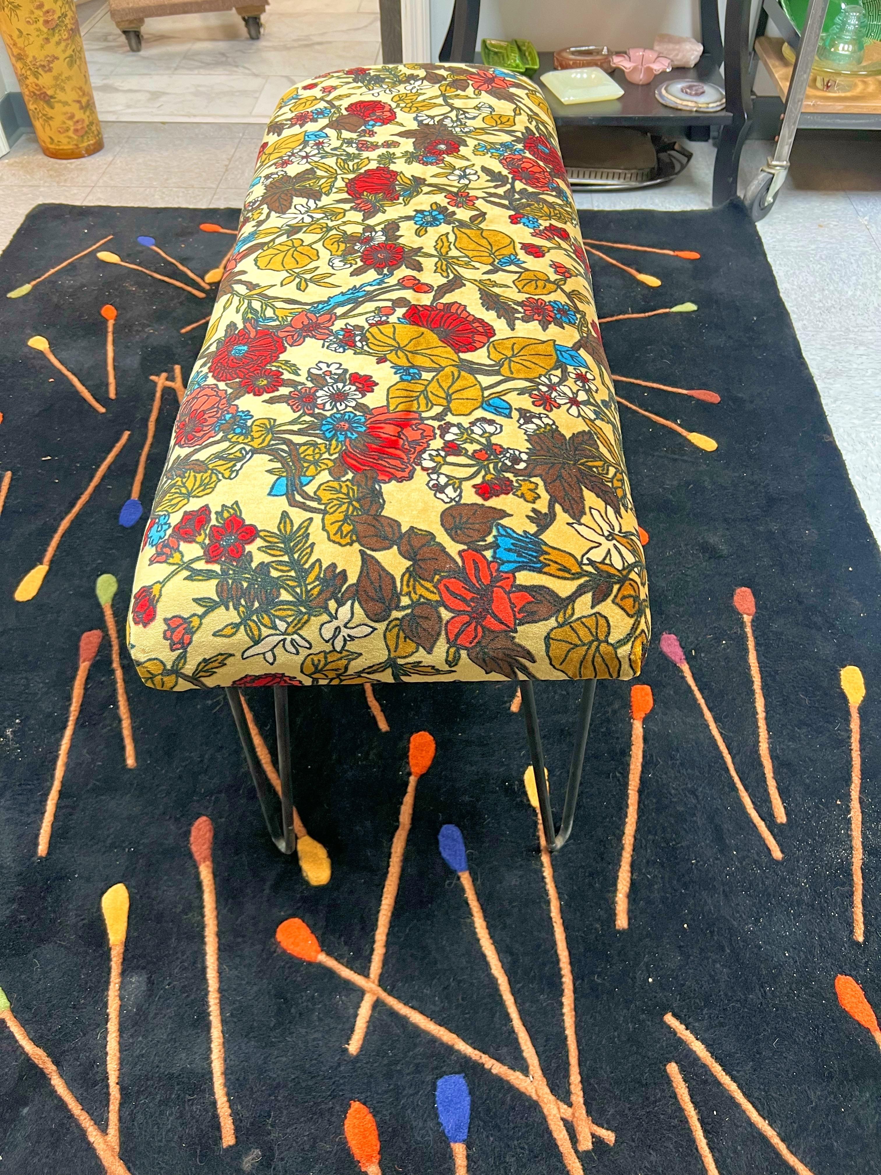 This lovely bench has been given a complete overhaul.  Original hairpin legs, new foam and padding.  Newly upholstered in old stock Jack Lenor Larsen style floral fabric.   The fabric has a gold tone background with bright florals.