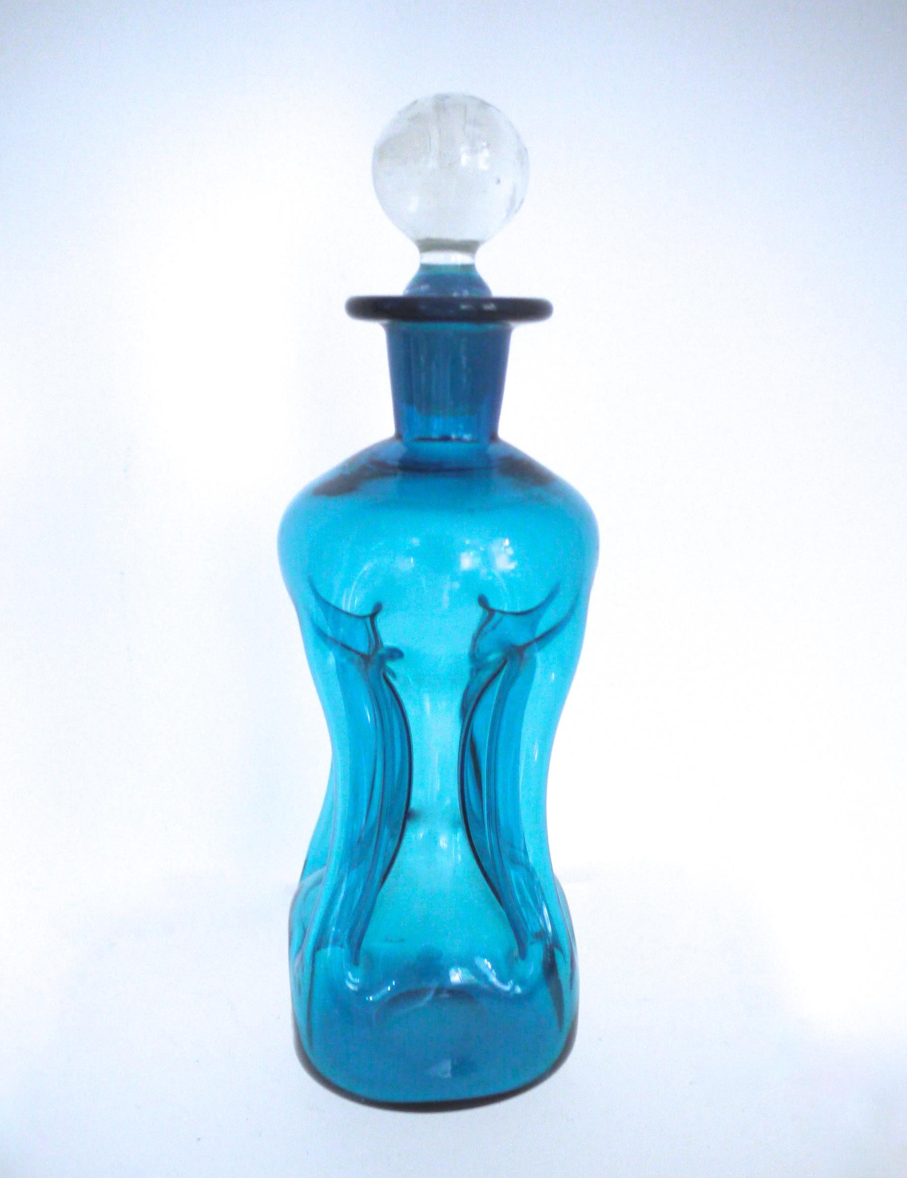 1960s Jacob Bang 'KlukKluk' Kingfisher blue glass decanter a seen on star trek

The iconic Jacob Bang 'Kluk Kluk' kingfisher blue art glass decanter was made by Holmegaard Glassworks of Denmark. Holmegaard traces its origins to 1823 and originally