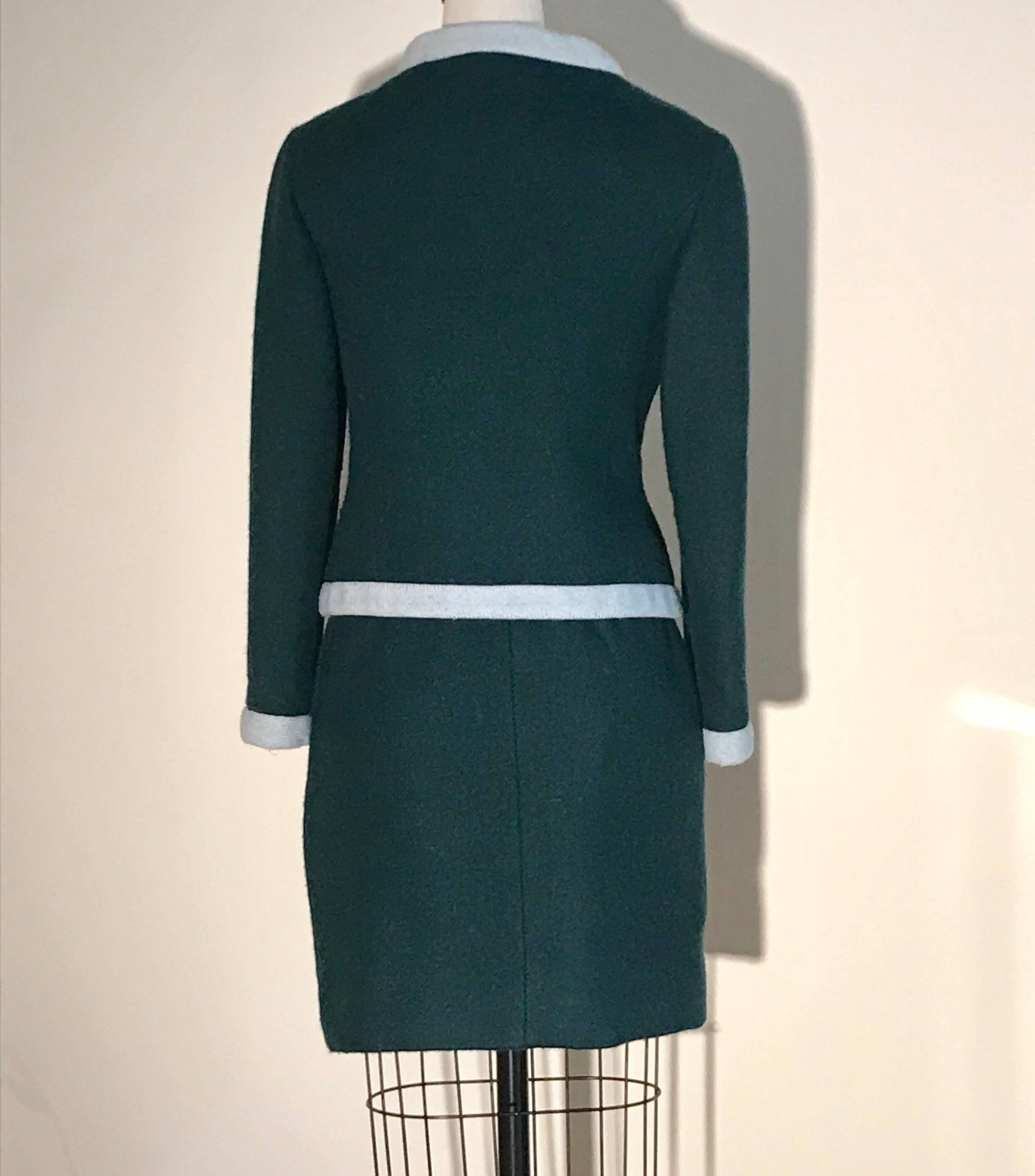 Vintage 1960s Jacques Heim for Jeannes Filles green skirt suit with light blue trim made for retailer Bonwit Teller. Side zip and hook and eye at skirt, five buttons at jacket front. .
(Color is truest in closeup photos.)

No content label, feels