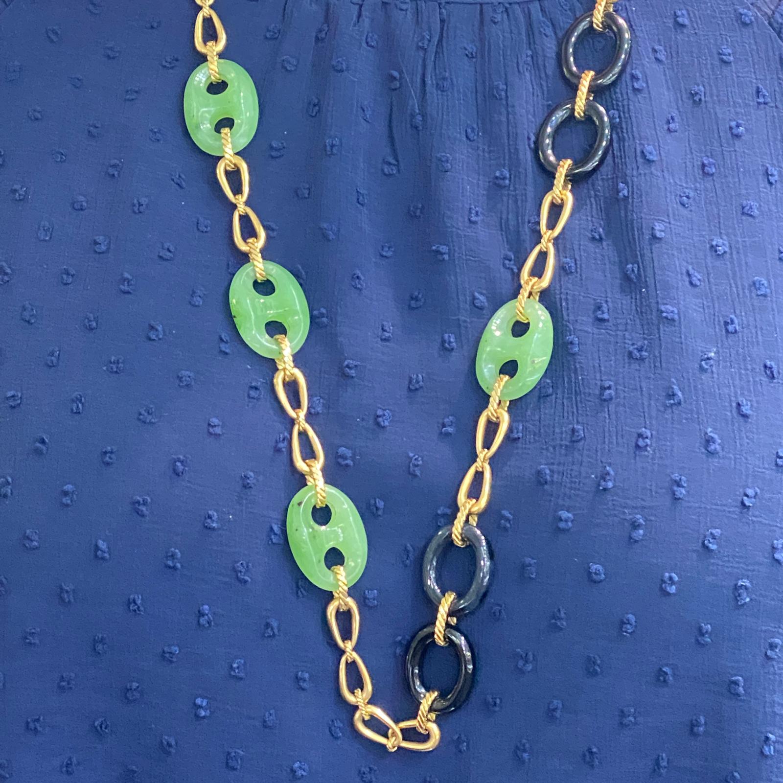 Chic jade, onyx, and 18 karat yellow gold link necklace circa 1960's. The 28 inch necklace features 7 jade gucci style links and 6 oval onyx links. The necklace is meant to be worn long-there is no clasp. 