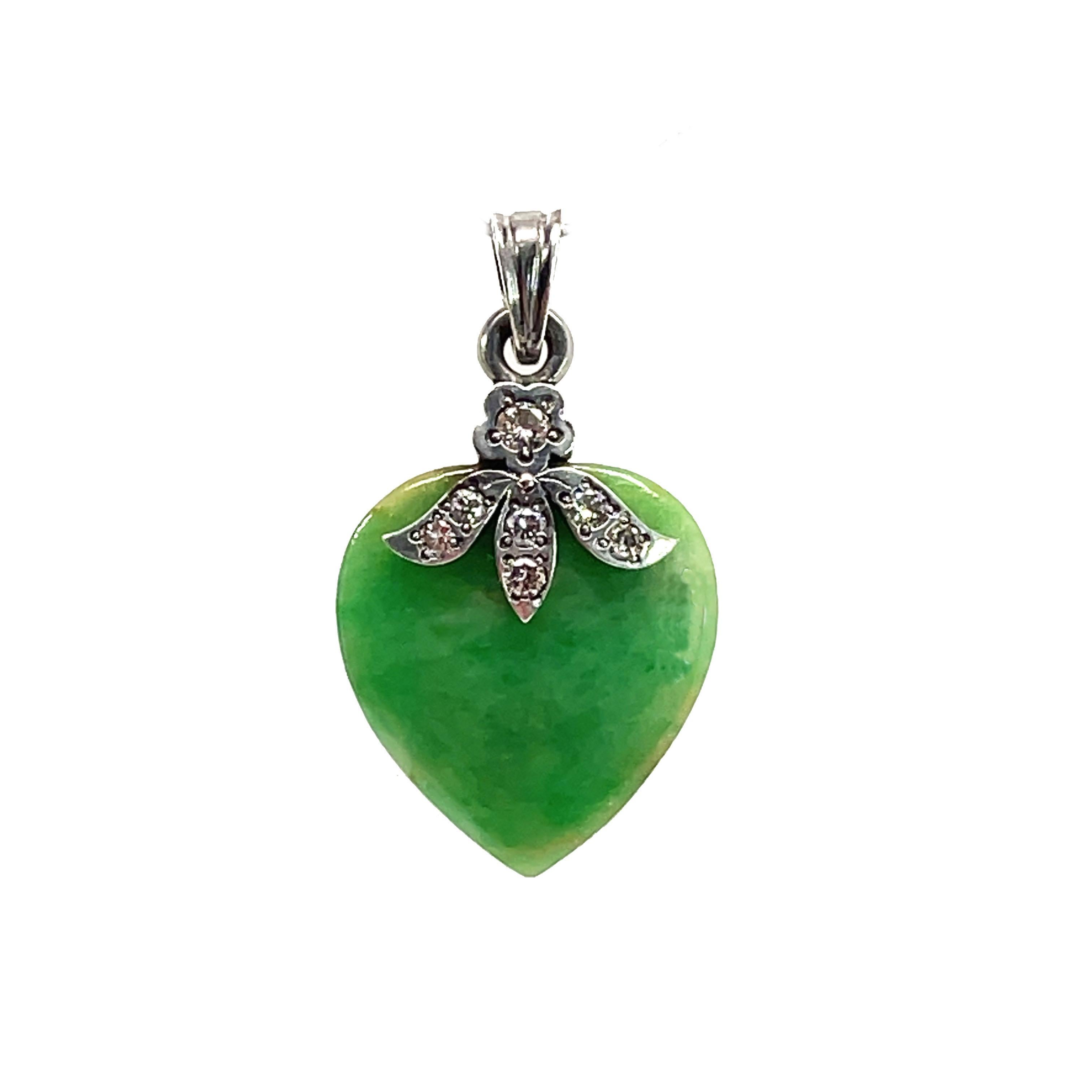 This is a beautiful sterling silver pendant from the 1960s with beautiful white diamonds and a heart-shaped jade!  This sweet pendant would make the perfect gift to someone you love! The Chinese associate jade with clarity of mind and purity of