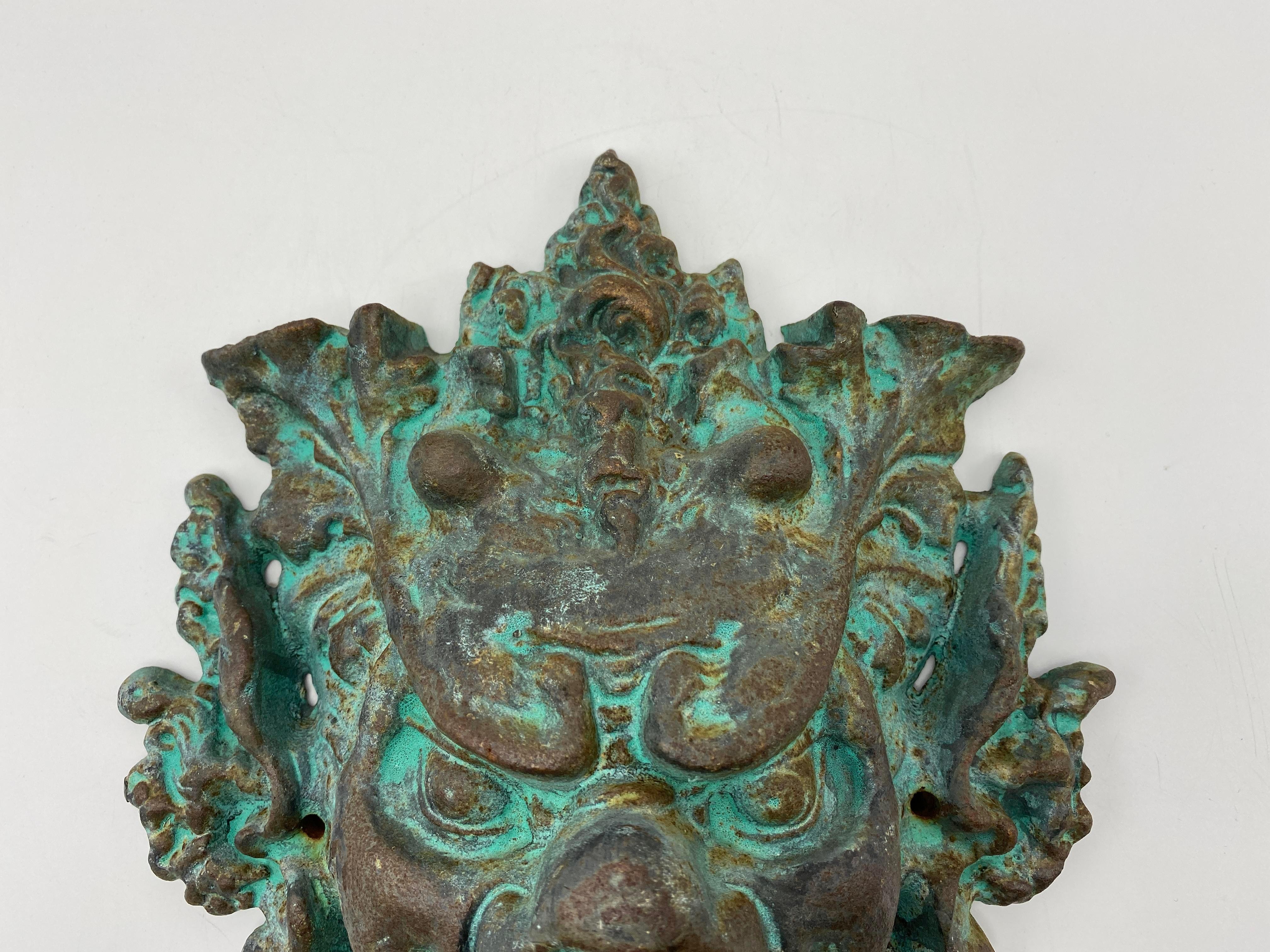 Listed is a magnificent, James Mont style sculptural door knocker in the form of Bacchus, circa 1960s. This substantial piece has a gorgeous patina allover, giving it some character and adding to the Brutalist, spook factor. 

Incredibly heavy,