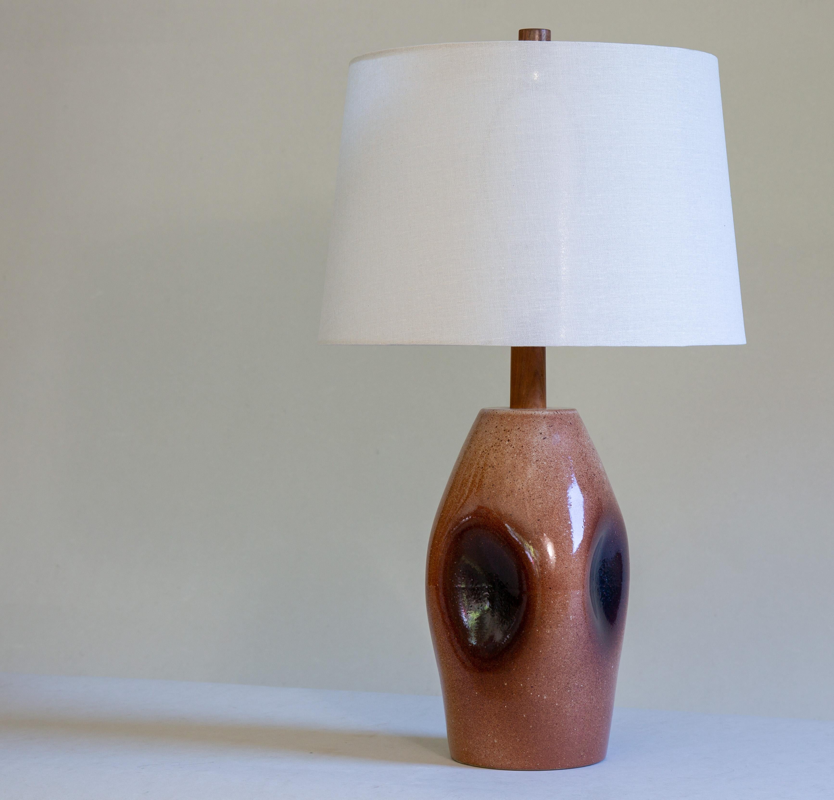 This lamp has a custom shape as confirmed by daughter Ann Martz, The shape never appears in any of the catalogues and was likely a firing mishap that turned in to a one off custom lamp.  Dimpled on 4 edges the glaze accumulates in the dimples and