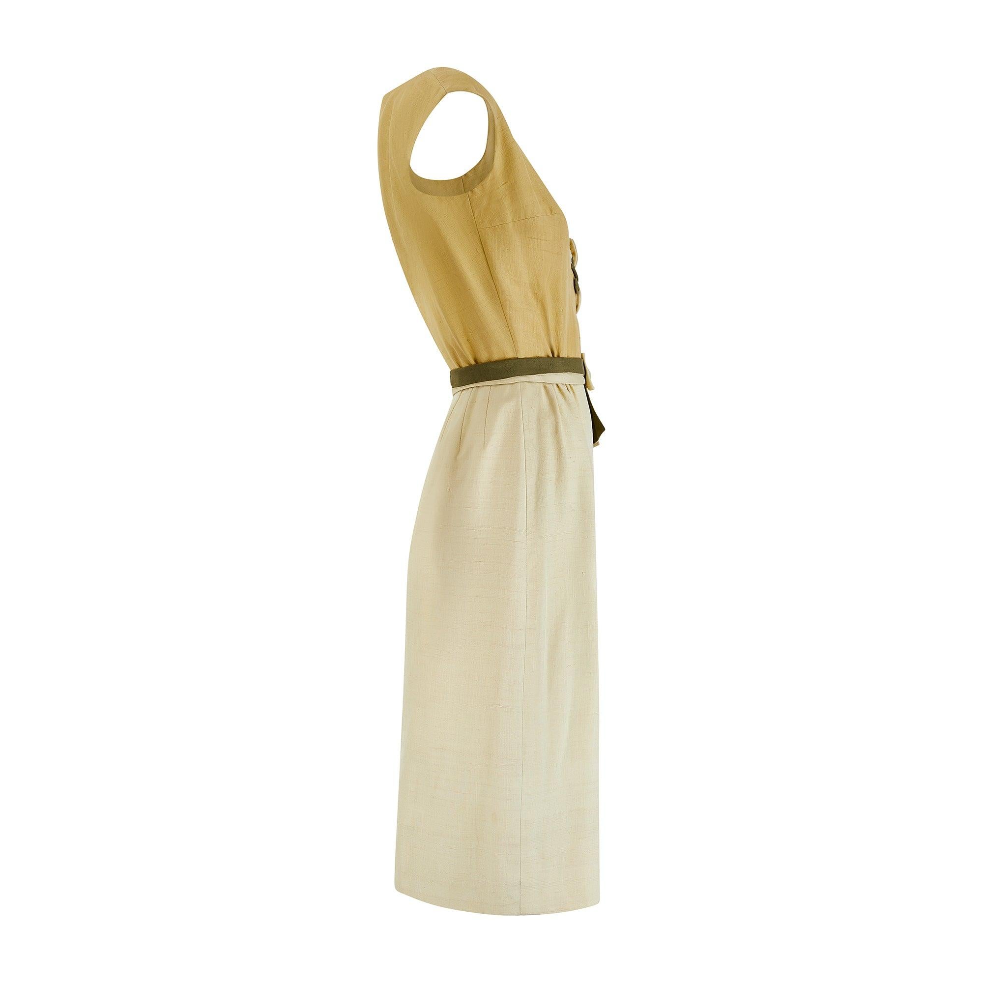Designed by Jane Frye, this pretty sleeveless dress is almost certainly an early 1960s piece. It is crafted from soft, lightly textured silk or a silk blend in three complementary hues of green and adorned with sculptural appliqué of roses, buds,