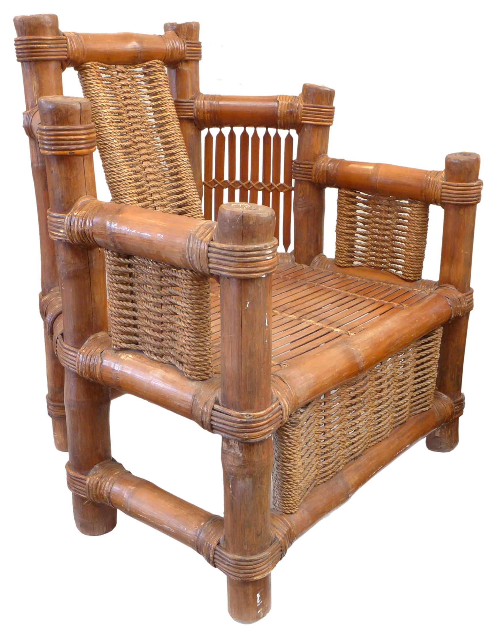 A wonderful 1960s Japanese bamboo, rattan and rope armchair. Impressively and thoroughly constructed, a thick bamboo stalk frame joined with rattan details, filled out with bamboo slats and woven rope. Finished in a uniform, warm mahogany hue. An