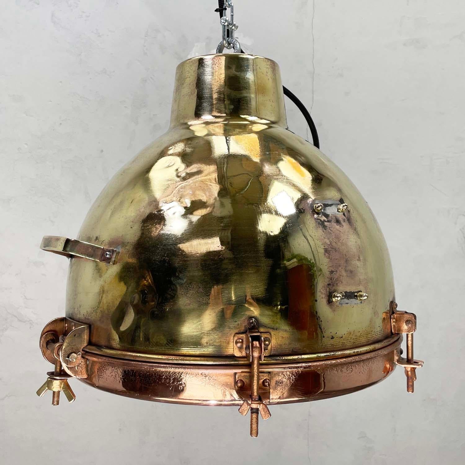 Brass and copper pendant with convex glass, a great design and becoming more difficult to find. These lights were made in the 1960s, the ships from this period are fast disappearing.

The patina shows a good life on the high seas where they would