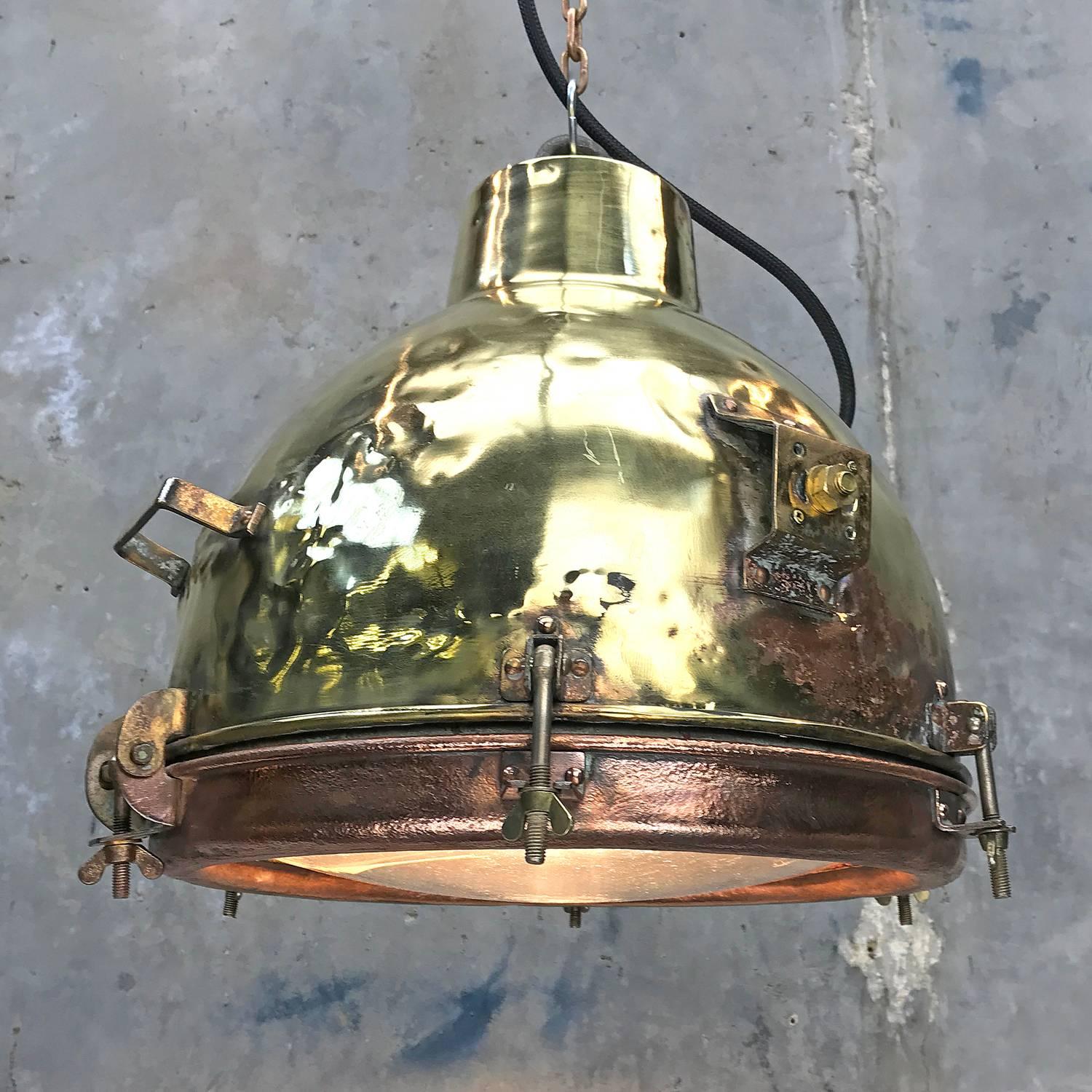 Brass and copper pendant with convex glass, a great design and becoming more rare. These lights were made in the 1960s, the ships from this period are fast disappearing.

The patina shows a good life on the high seas where they would have been