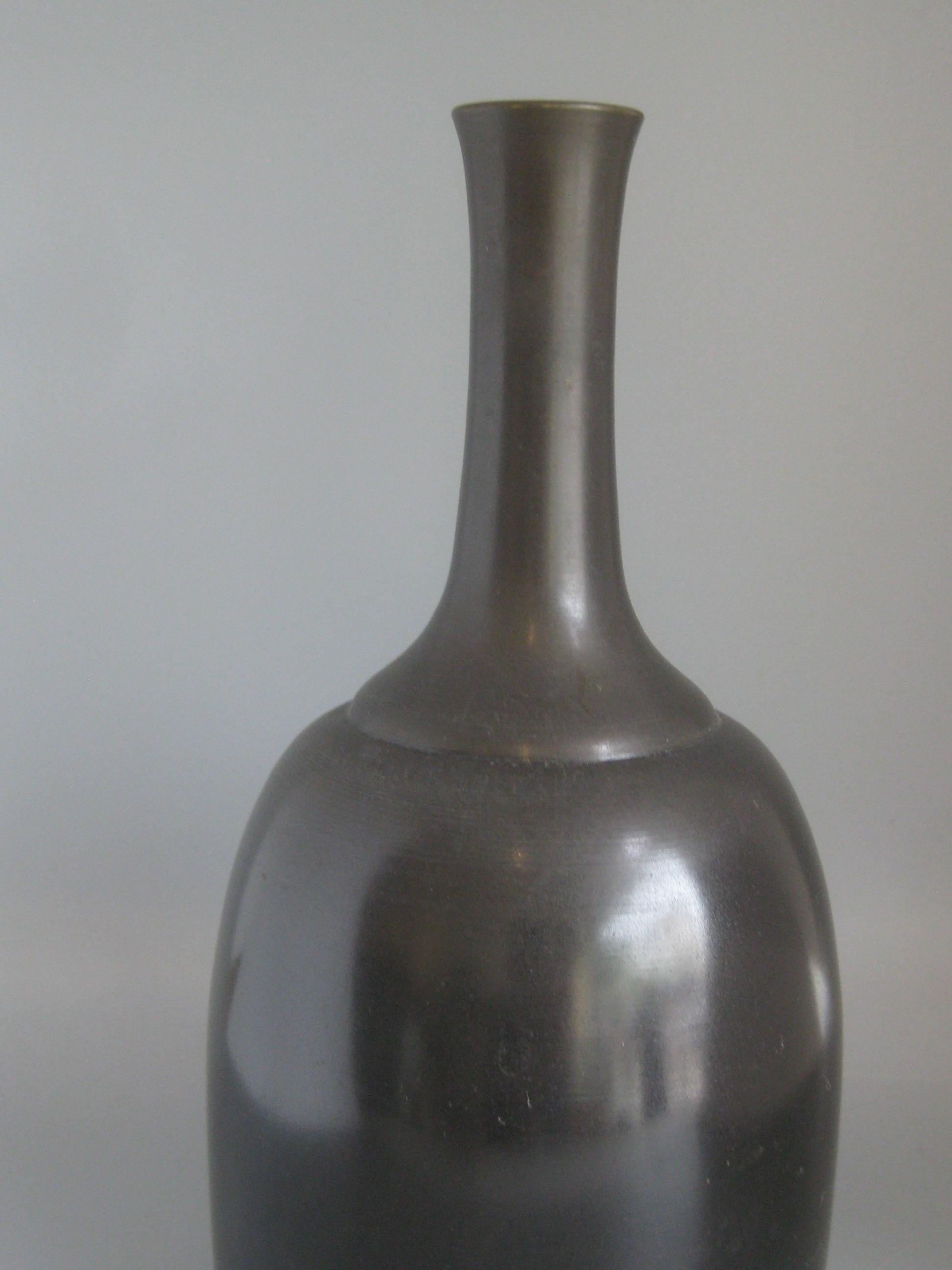 Outstanding Japanese modernist Ikebana bronze vase/vessel, circa 1960s. Sold by Neiman Marcus of Japan. Wonderful form and design. Has the original paper label on the bottom. In very nice condition for its age. No chips, no dents, no cracks and no