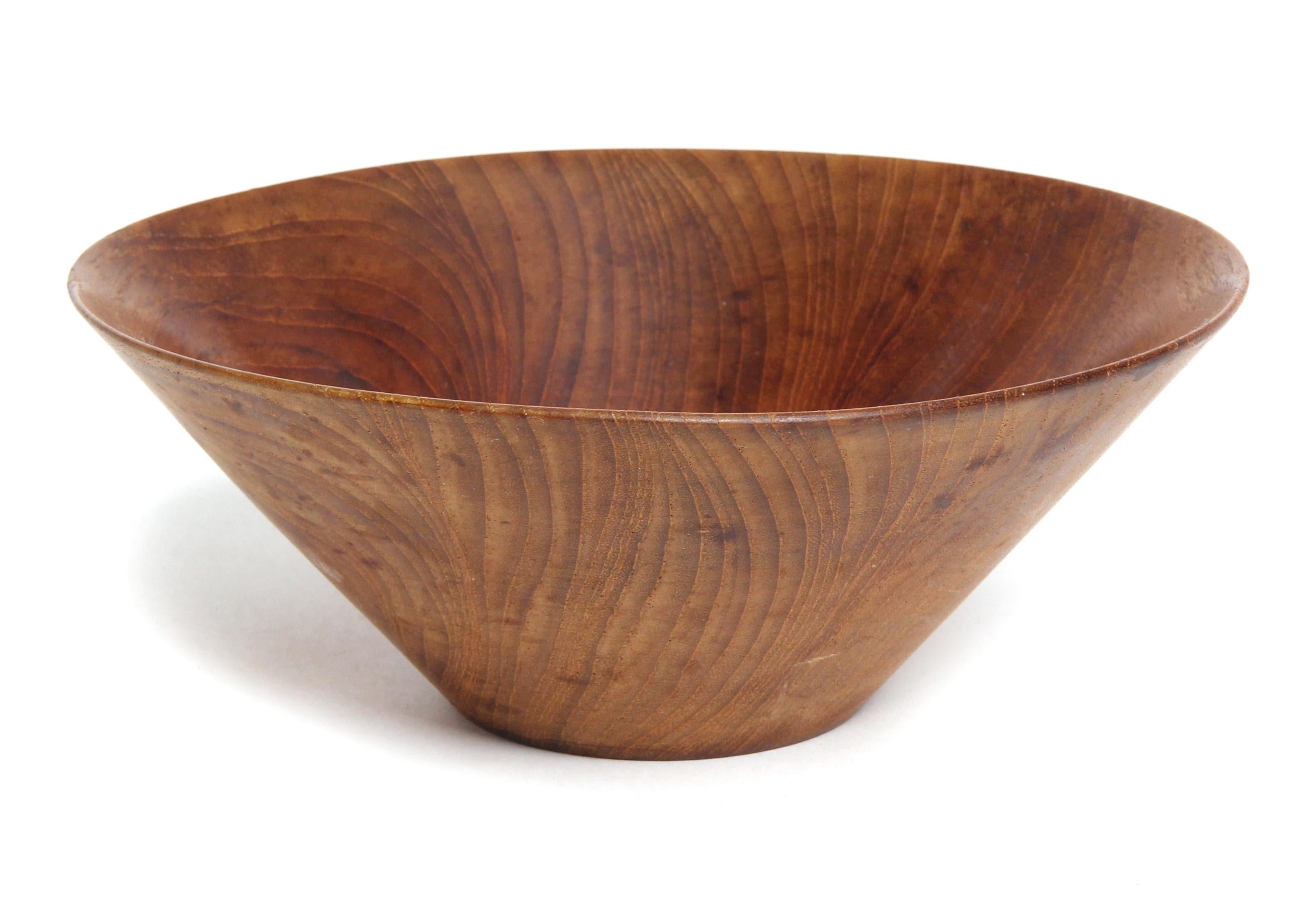 A thin walled lathe turned active grained wood bowl having flaring conical form.