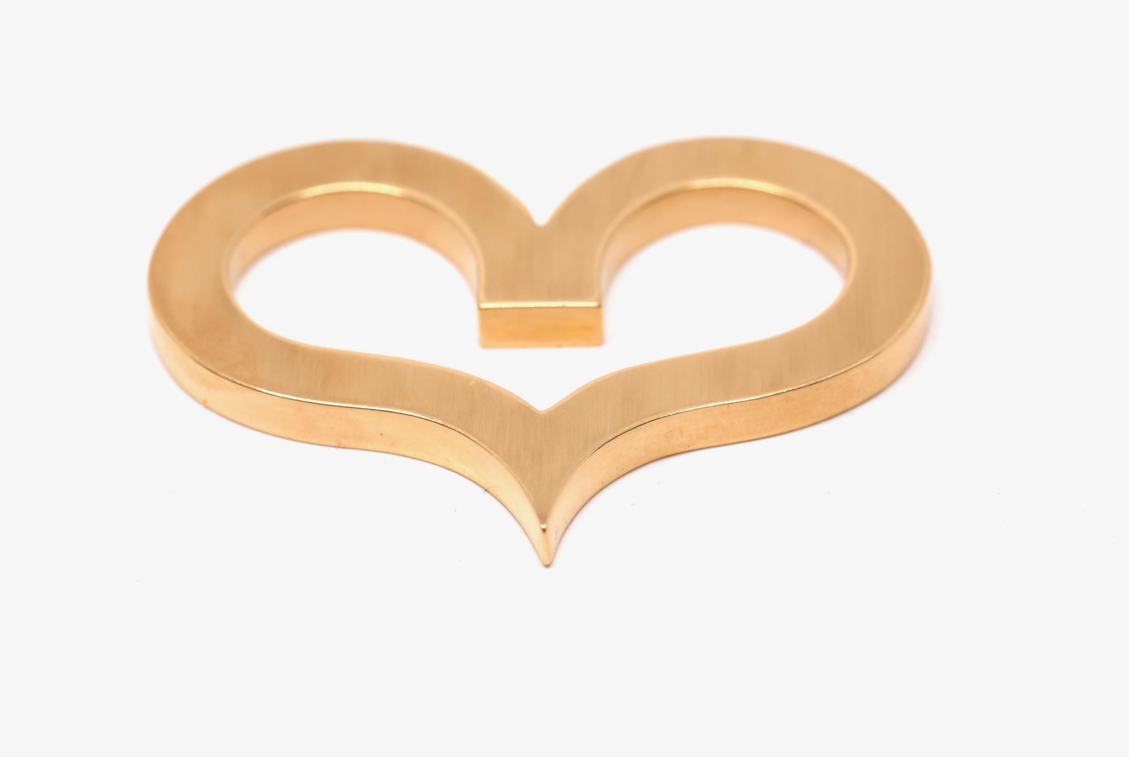 Oversized, 18k yellow gold open heart pendant designed by Jean Dinh Van for Cartier dating to the 1960's. Pendant measures approximately 2