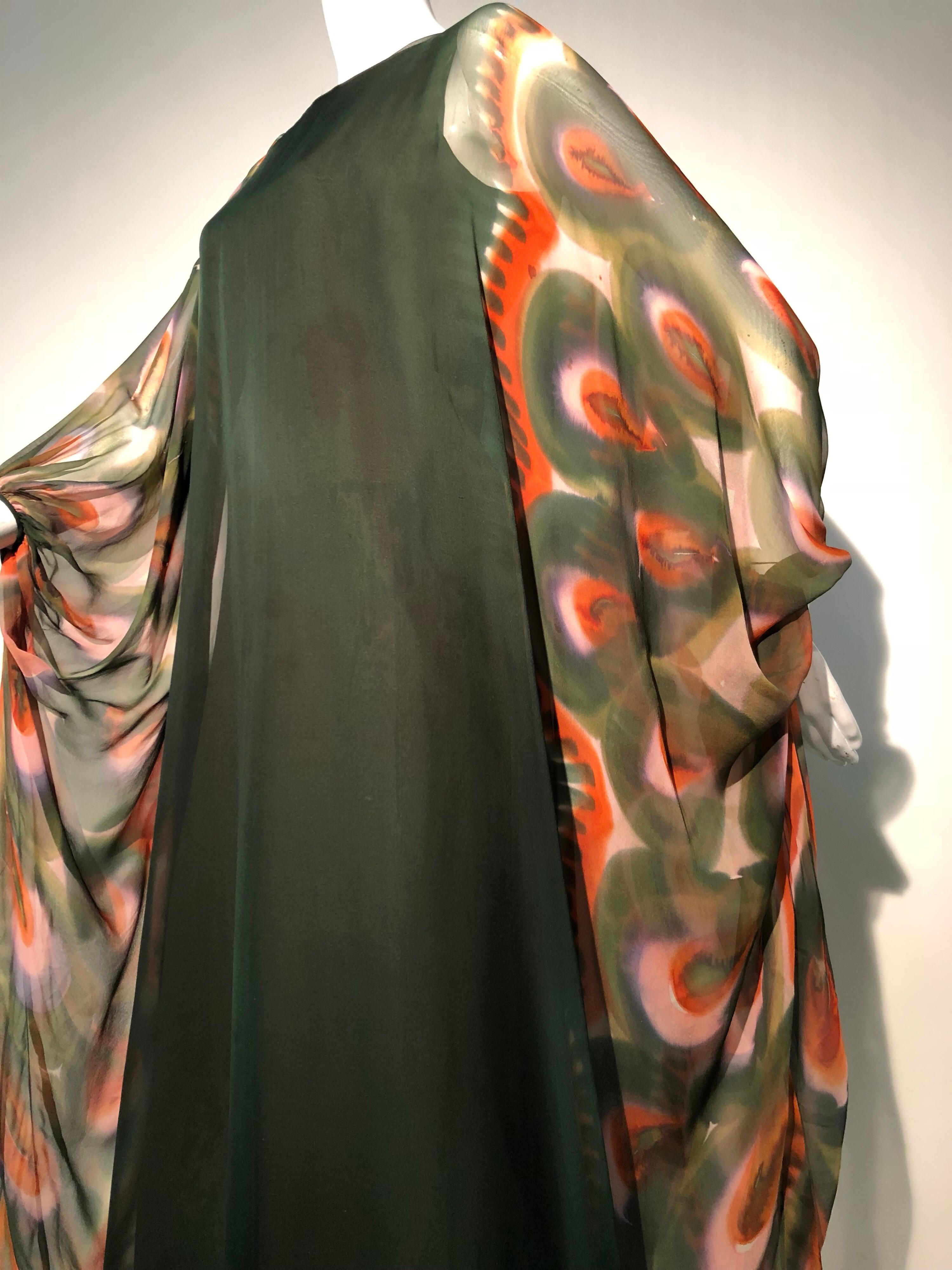 1960s Jean Louis deep moss green silk gown with hand-painted chiffon kaftan overlay. Gathered, piped cuffs. Zippered black. Coordinating silk crepe lining. 