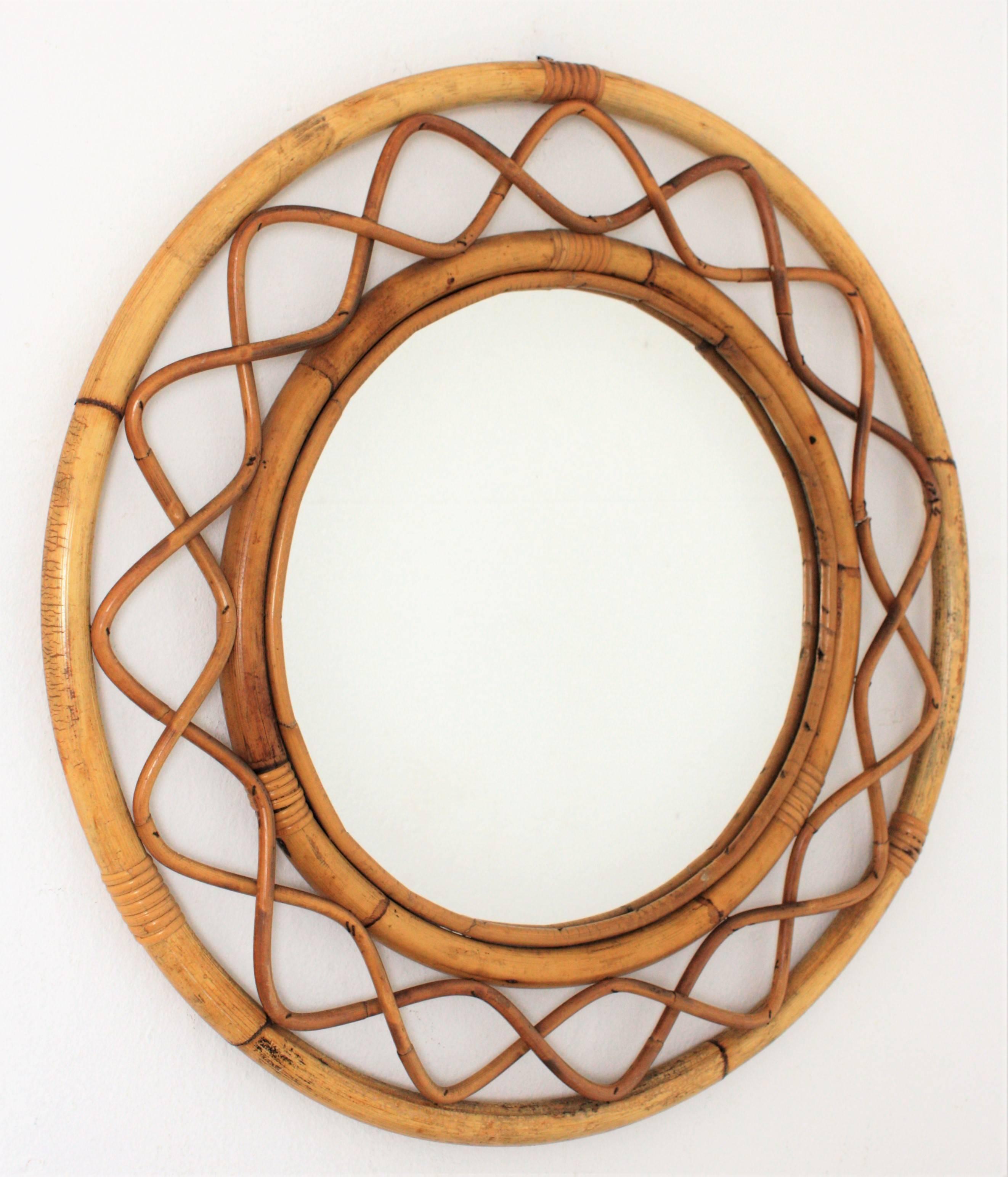 Beautiful handcrafted bamboo and rattan circular mirror with all the taste of the Mediterranean coast style. In the style of Jean Roye`re. France, 1960s.
 Lovely to place it alone and also beautiful creating a wall decoration with other mirrors in