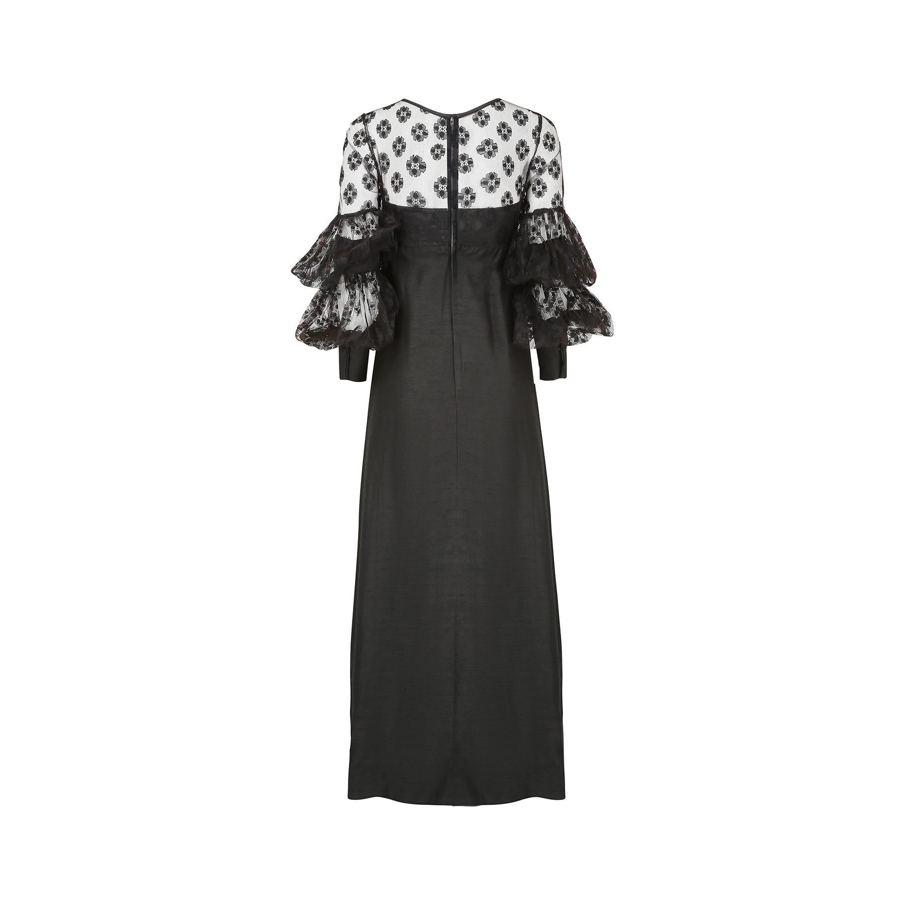 A very striking Jean Varon black lace maxi dress which dates from the late 1960s with a dramatic sleeve design that has not one but two lace balloon sections and an elongated cuff.  The lacework is an abstract floral design reminiscent of the flower