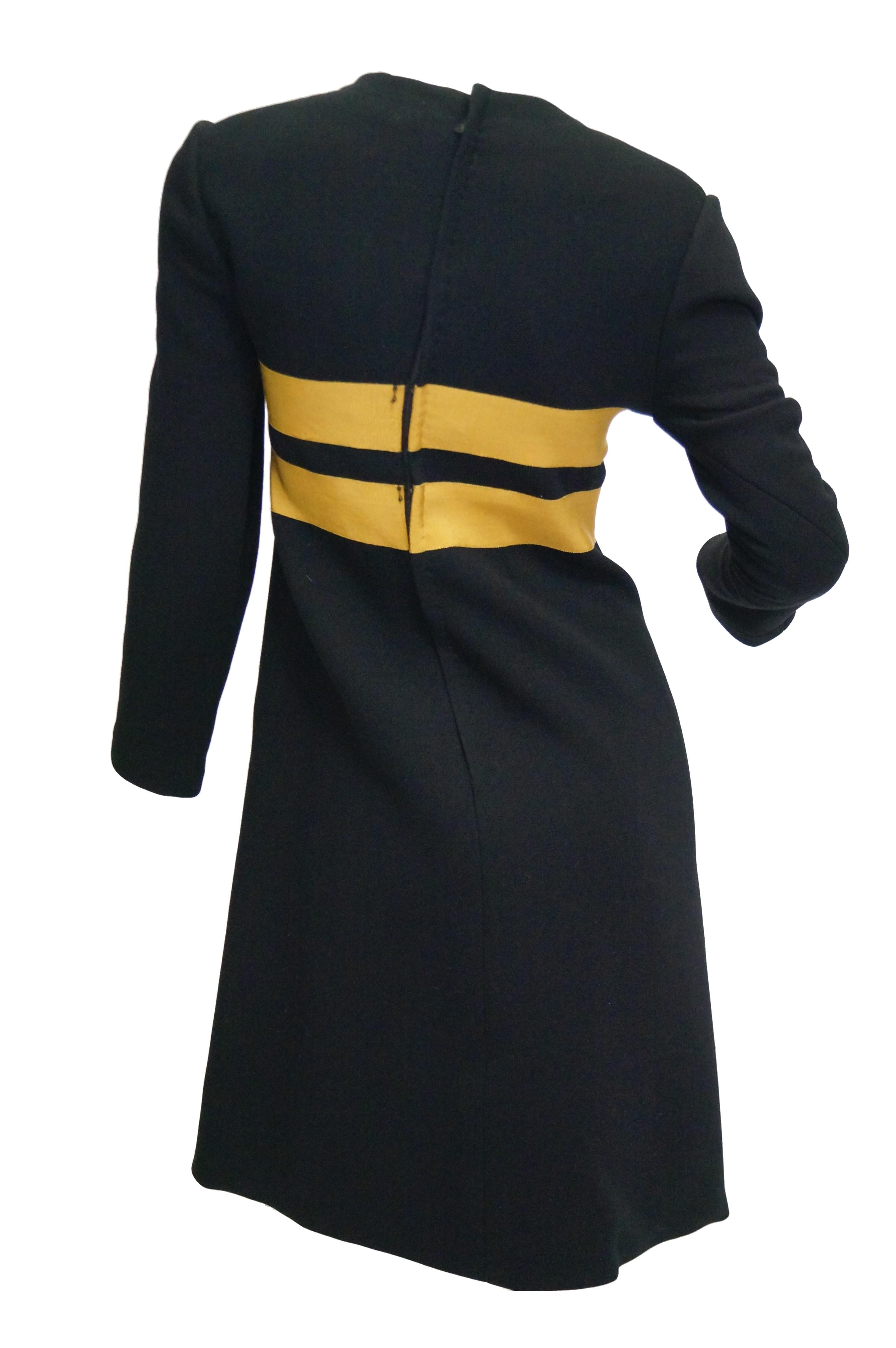 Wonderfully Mod dress created by Jeanne Lanvin and executed  with authorization by Maria Carine.  The black wool dress has a loose shift silhouette, jewel neckline, long sleeves, and falls just above the knee. The bust of the dress features two