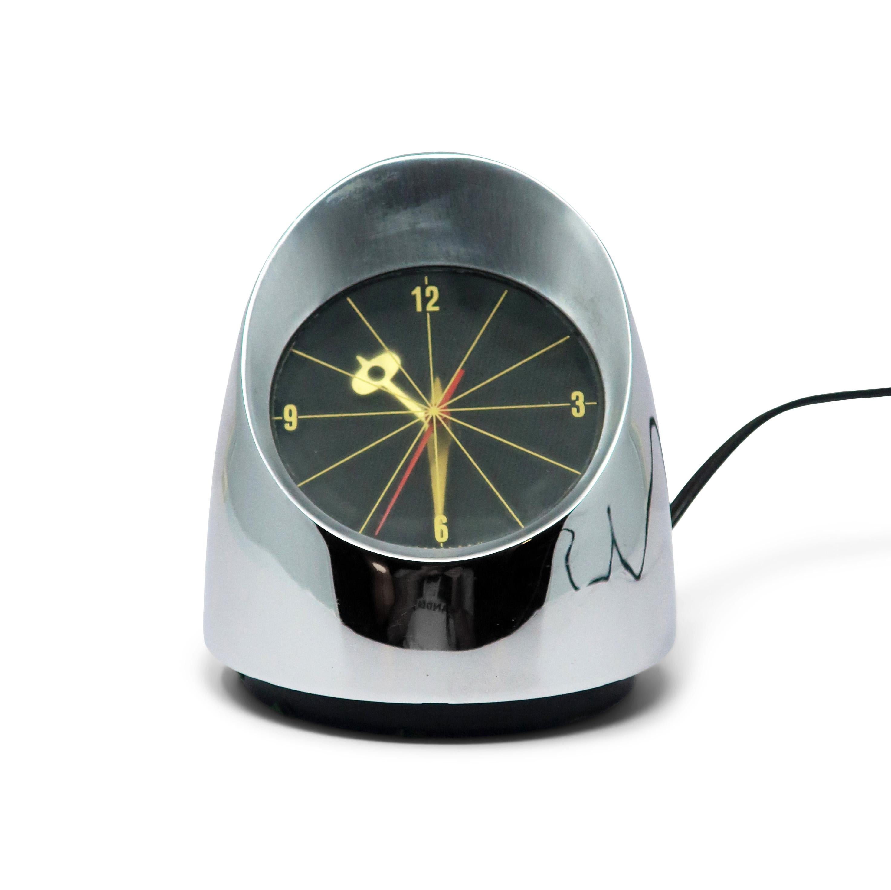Inspired by a ship's compass, the Jefferson 500 is a perfect Space Age desk clock design with a polished chrome case, satin chrome surrounding the dial, and a black plastic base with space to store excess cord. It adds a touch of sophistication and