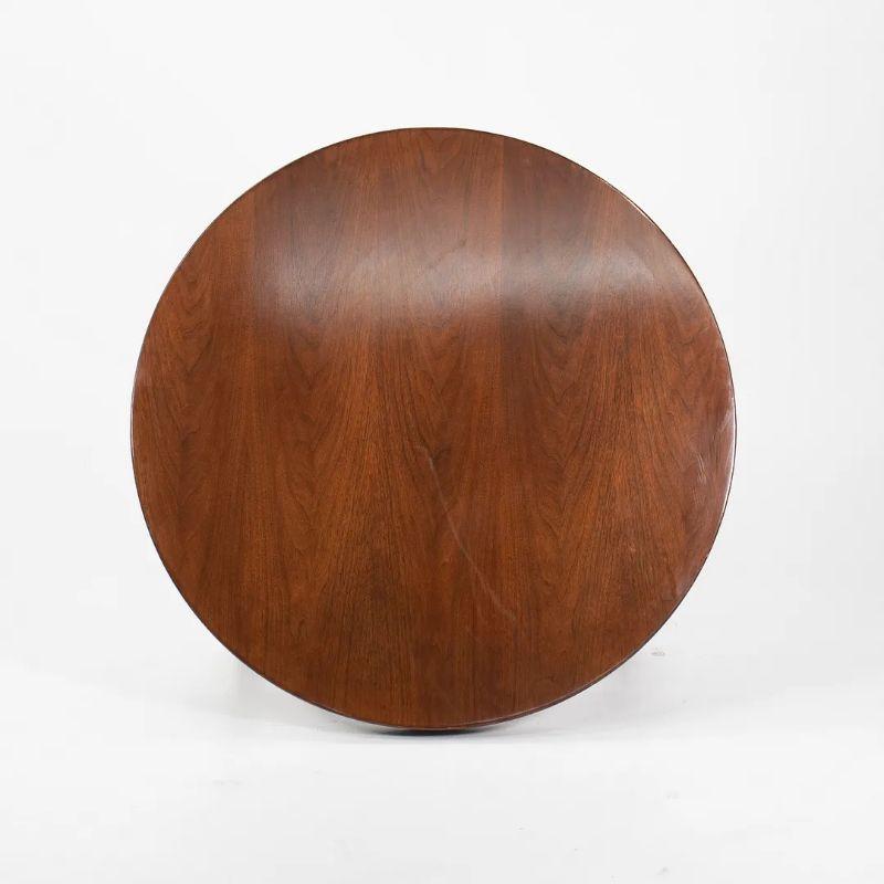 This is an original round walnut coffee table, designed by Jens Risom and produced by Jens Risom Design Inc. in the early 1960s. This timeless piece features classic Risom lines, and has a handsome detailed wood top. It is in fantastic original
