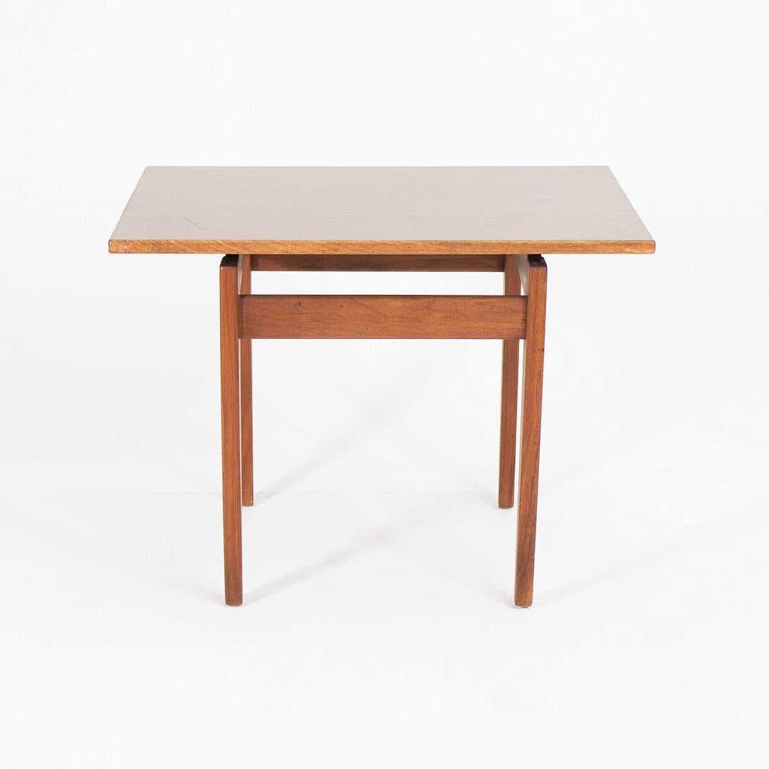 This is a Jens Risom Walnut Side Table, designed by Jens Risom in 1950 and produced by his company, Jens Risom Design Inc., in the 1960s. The Table's design is composed of a floating laminate top supported by a sculpted walnut base.

The table
