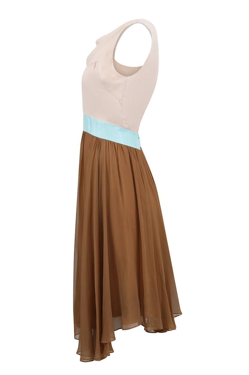 This lovely 1960s silk chiffon crepe dress in tan, nude and turquoise tones is labelled Jeunesse New York and is in pristine vintage condition with a youthful, contemporary feel. The dress is sleeveless with a simple shift cut and subtle cowl
