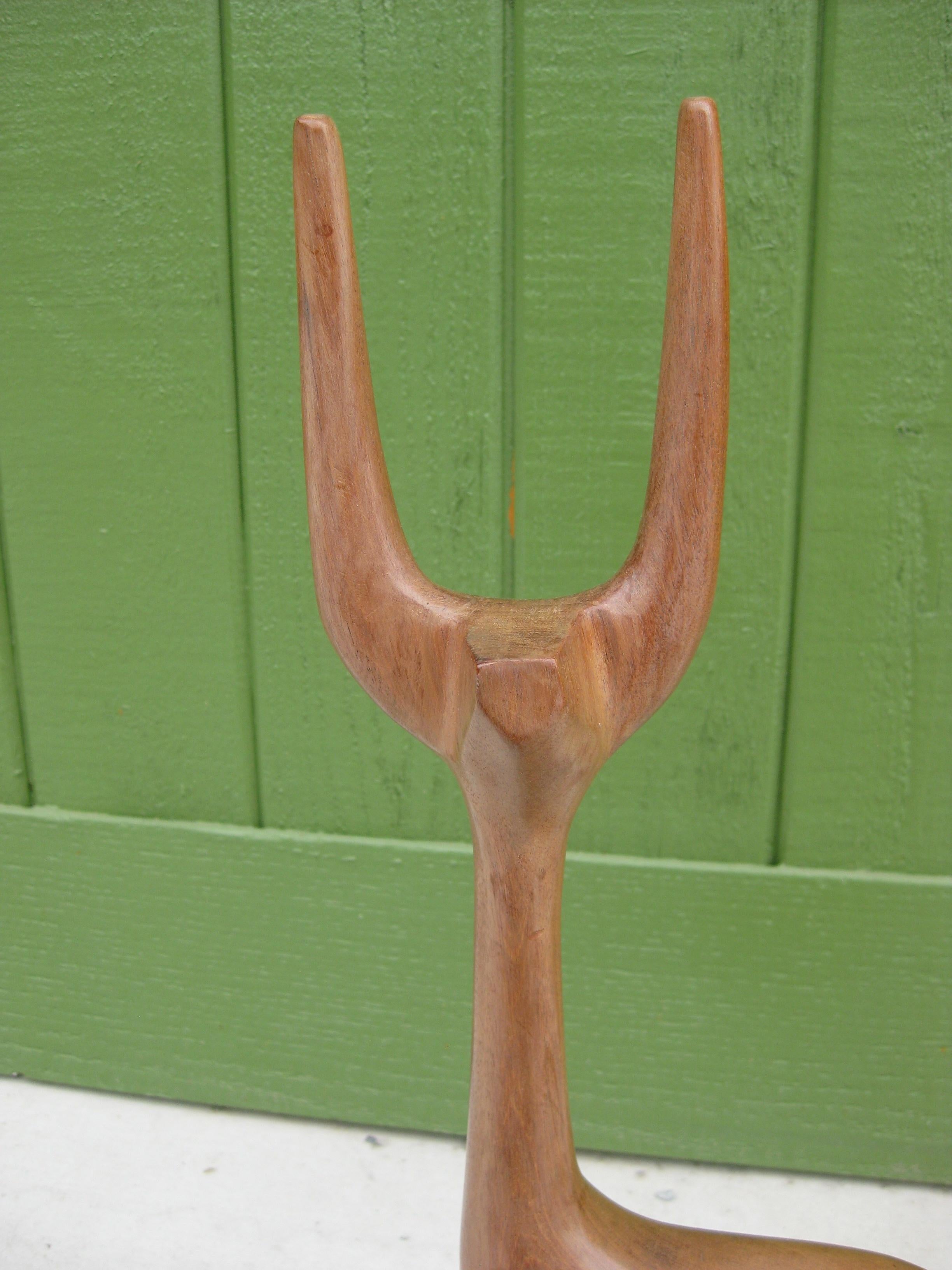 We are offering a wonderful hand carved wood animal sculpture by Mexican artist, J.G. Casas, circa 1960's. The sculpture has the original JOM Calidad, Mexico tag on the bottom. Great abstract design and form. Appears to be a deer, pronghorn or
