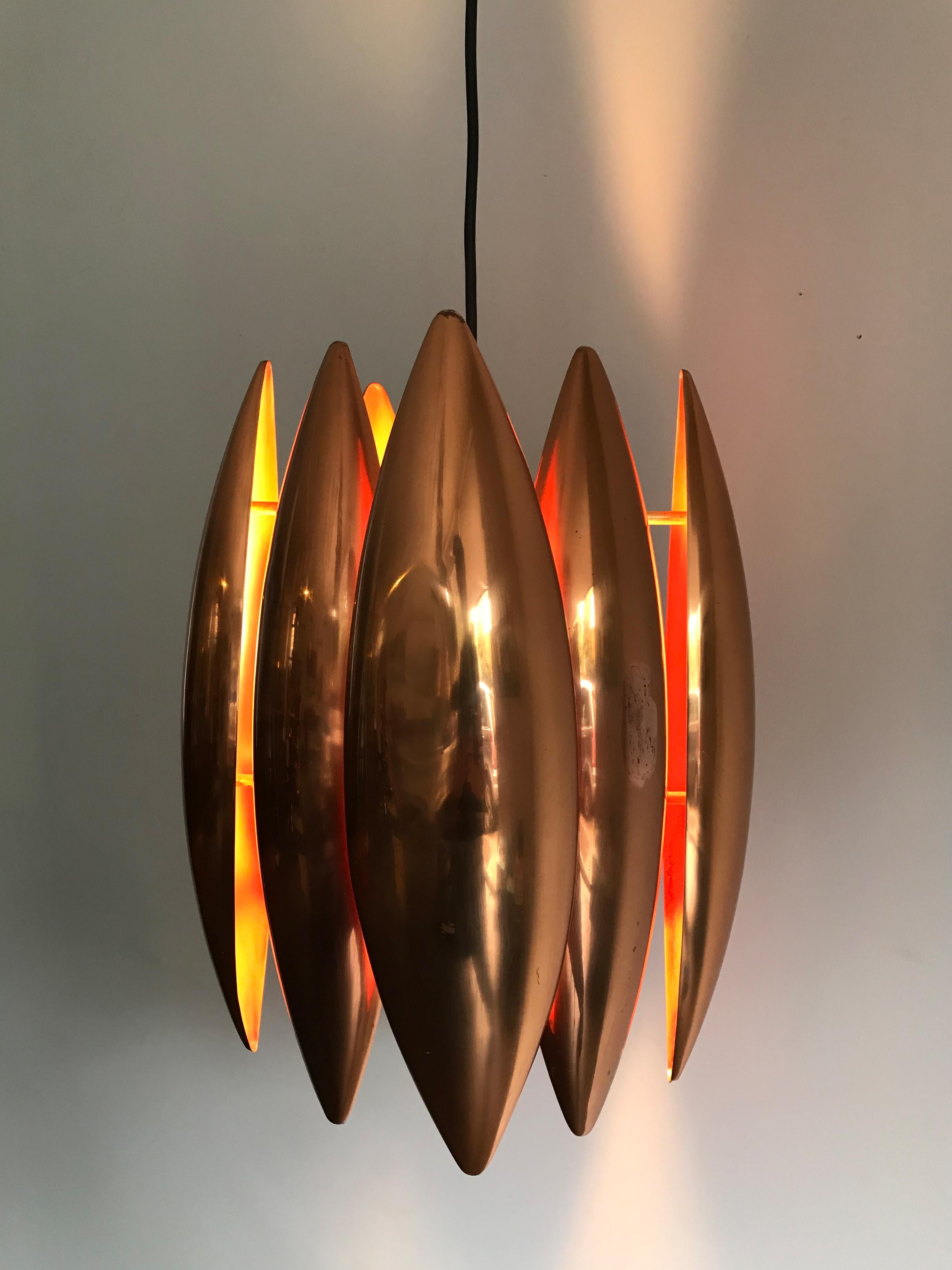 1960s amazing and very rare copper Scandinavian pendant lamp model Kastor designed by Jo Hammerborg for Fog & Morup, made in Denmark.
Source: Fog & Morup catalogue 1969.

When the lamp is on it diffuses a very warm, sophisticated and welcoming
