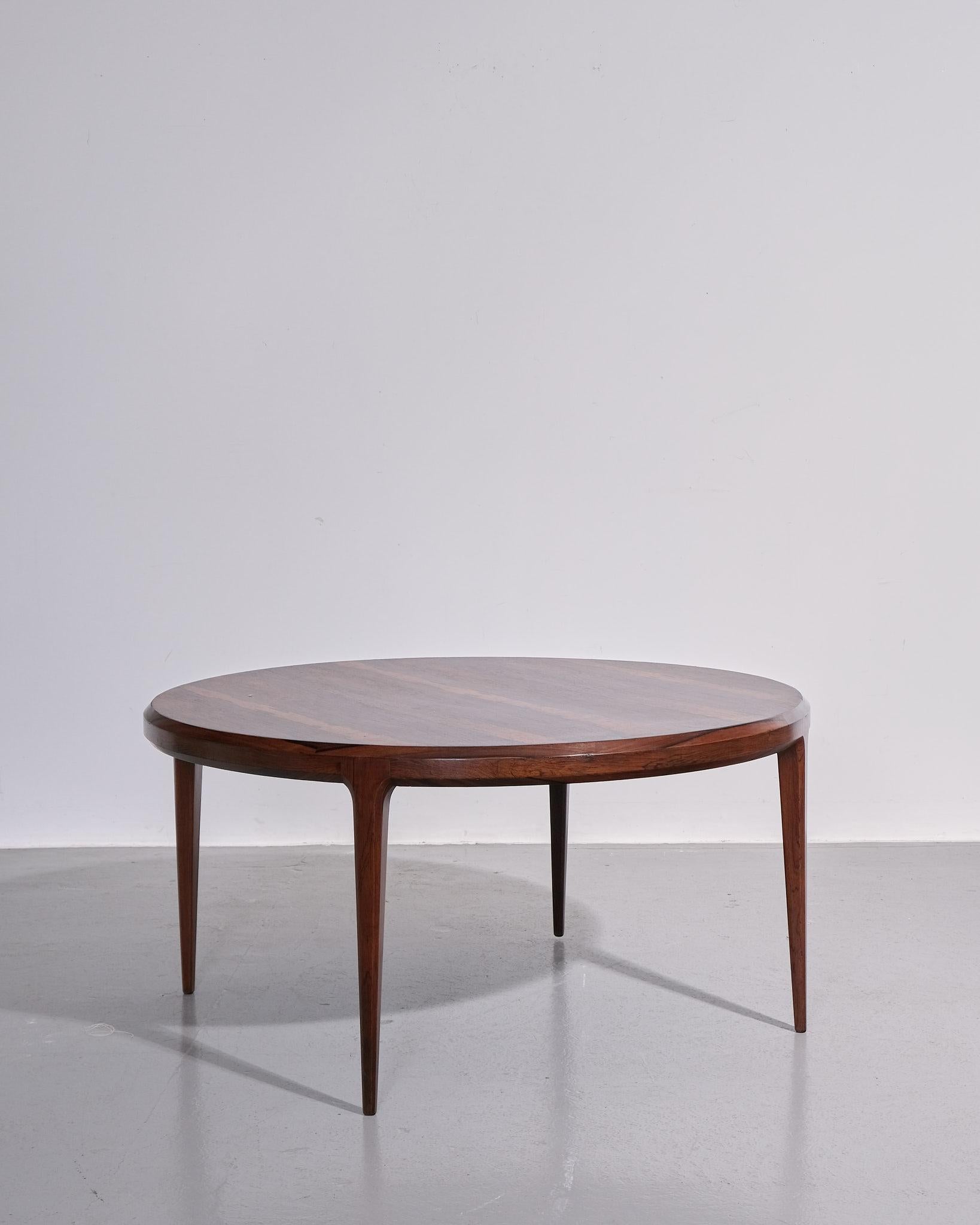 A striking circular rosewood coffee table by Danish designer Johannes Andersen, made for CFC Silkeborg circa the 1960s. Crafted in richly grained Rio rosewood, this table exemplifies the elegance and refinement of mid-century Danish modern design,