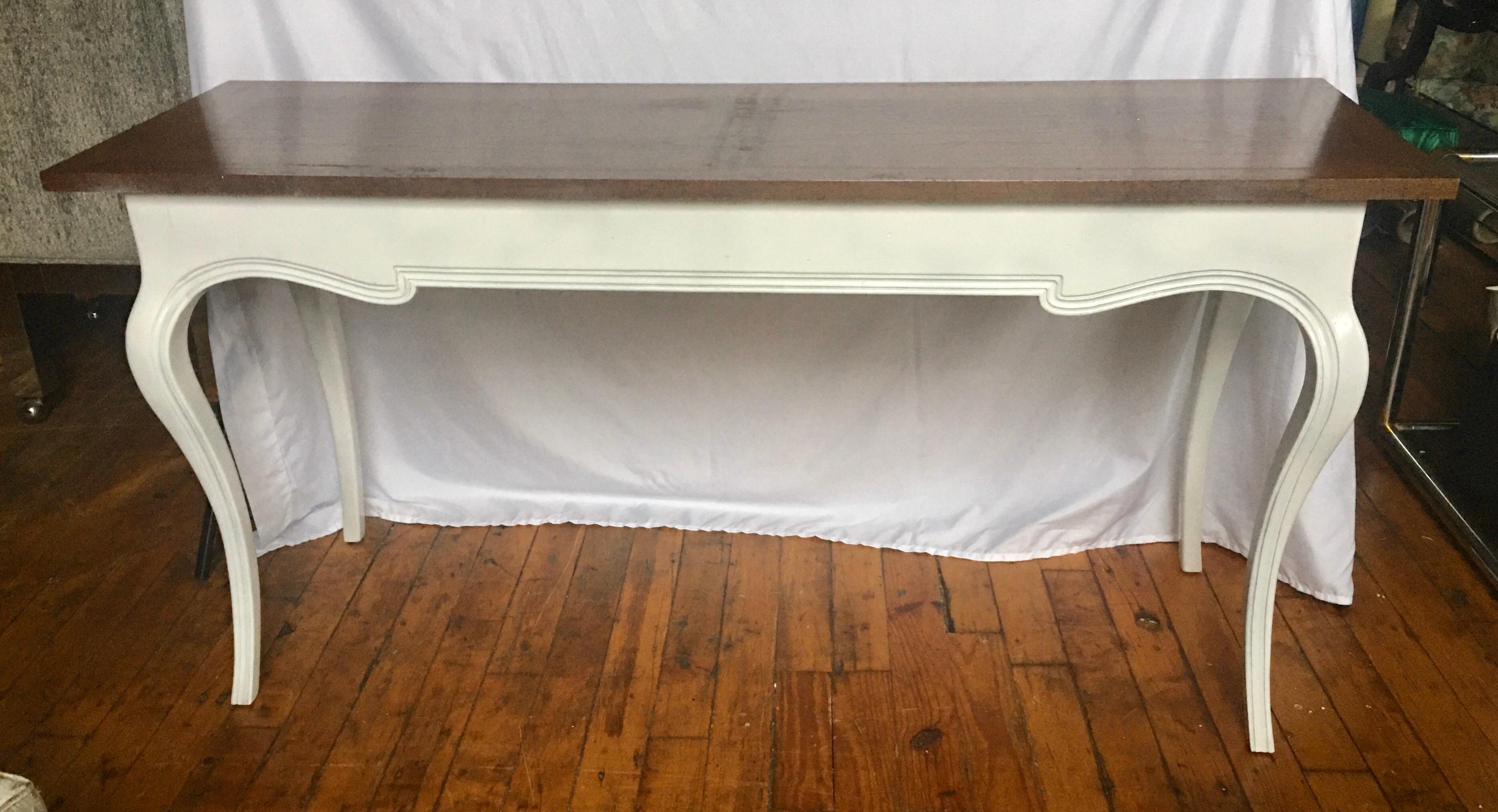 Midcentury French Provincial style console sofa table by John Stuart. Base features a white painted finish with curved cabriole legs and one single drawer. Top is stained wood. Table could also be used as a long desk.