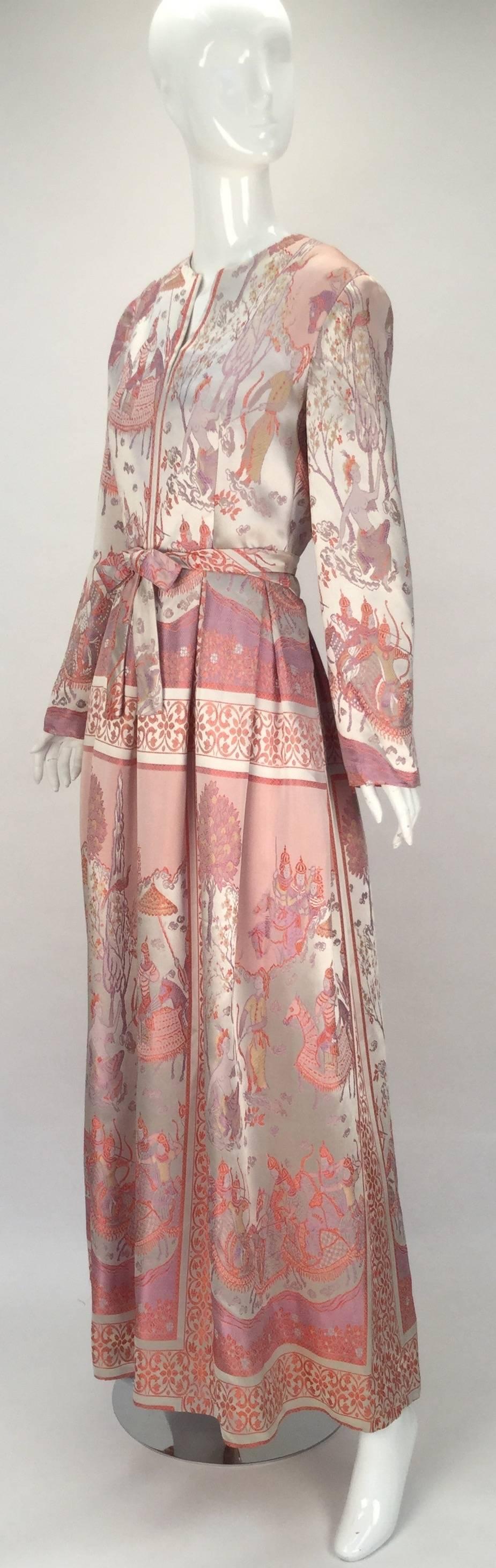 
Gorgeous 1960's Jon Mandl silk 'Asian warrior and floral' motif evening dress. The dress was originally purchased at Helen Morrell, an exclusive boutique in Wurtsboro, NY. Scoop neckline that falls into a V at center front. A matching fabric belt