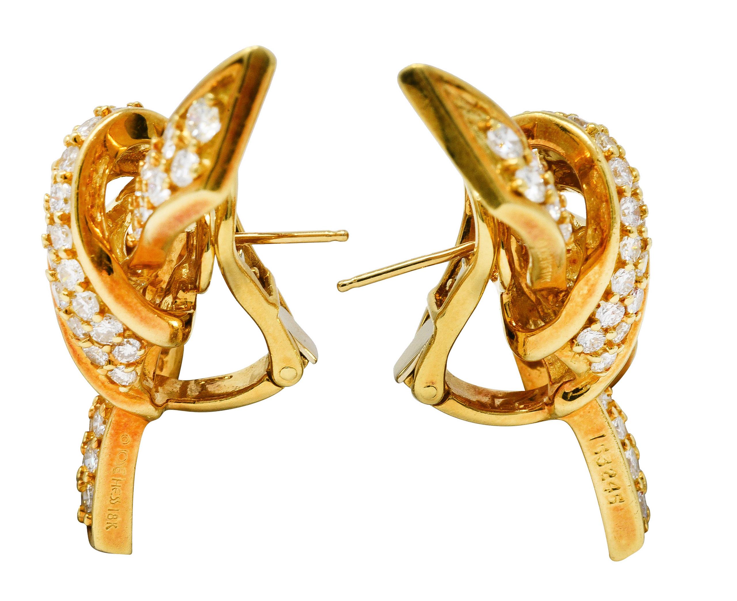 Earrings are designed as twisted gold knots - oriented North to South. Pavè set throughout by round brilliant cut diamonds. Weighing in total approximately 3.45 carats - F/G color with VS2 to SI1 clarity. Completed by posts with hinged omega backs.