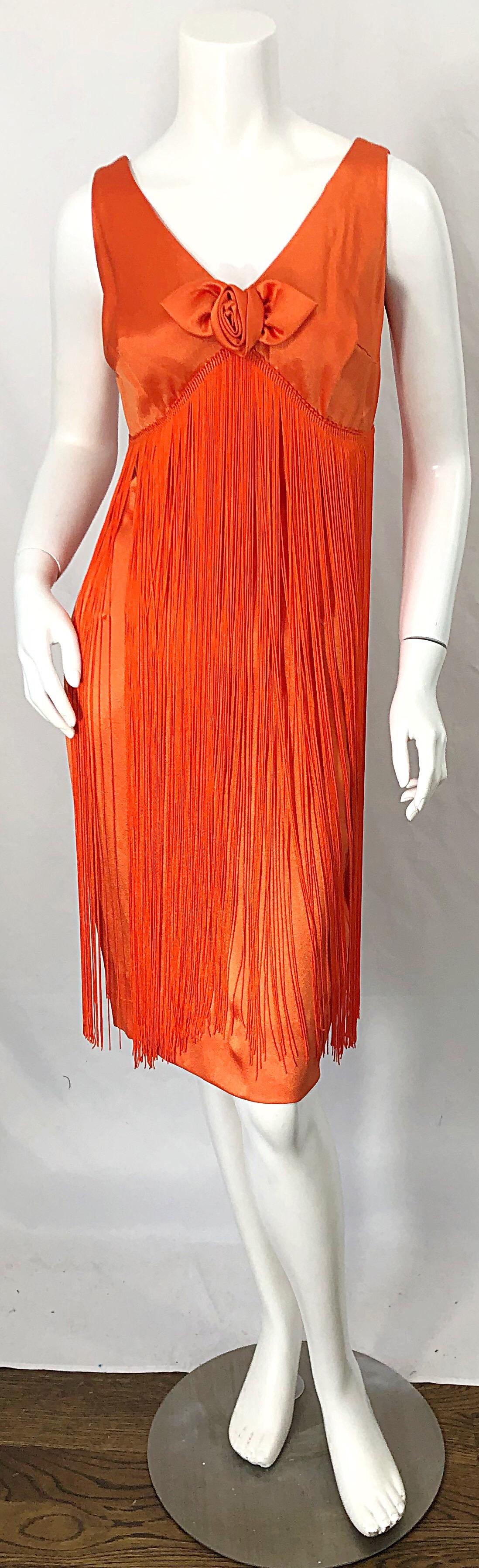 Beautiful vintage 1960s JOSEPH MAGNIN bright neon orange fully fringed flapper dress ! Features the perfect color orange, with hundreds of strands of Fringe throughout the entire dress. Hidden metal zipper up the back with hook-and-eye closure.