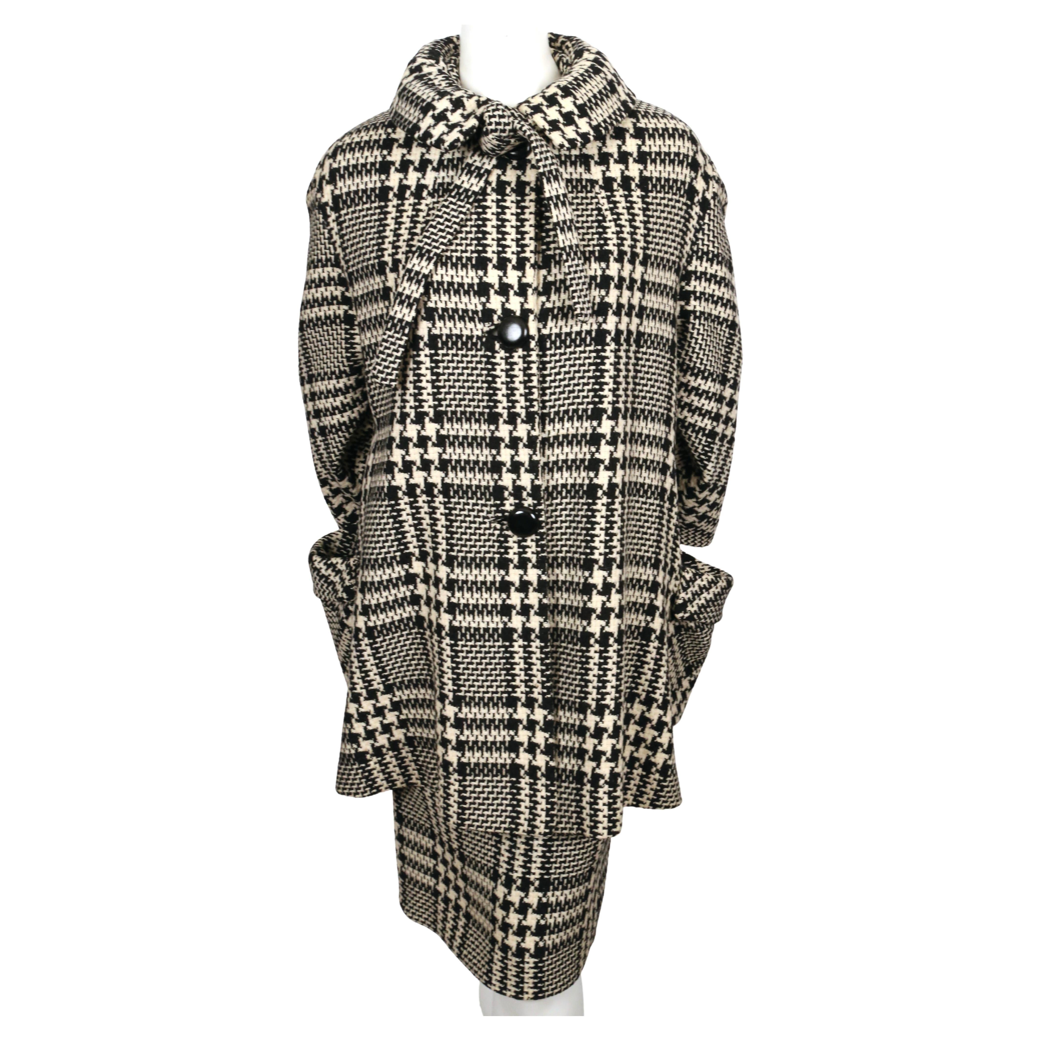 Cream and black houndstooth woven wool swing coat with necktie and matching skirt made for Joseph Magnin dating to the 1960's. Coat fits many sizes due to loose cute. Approximate measurements of coat: drop shoulder 20