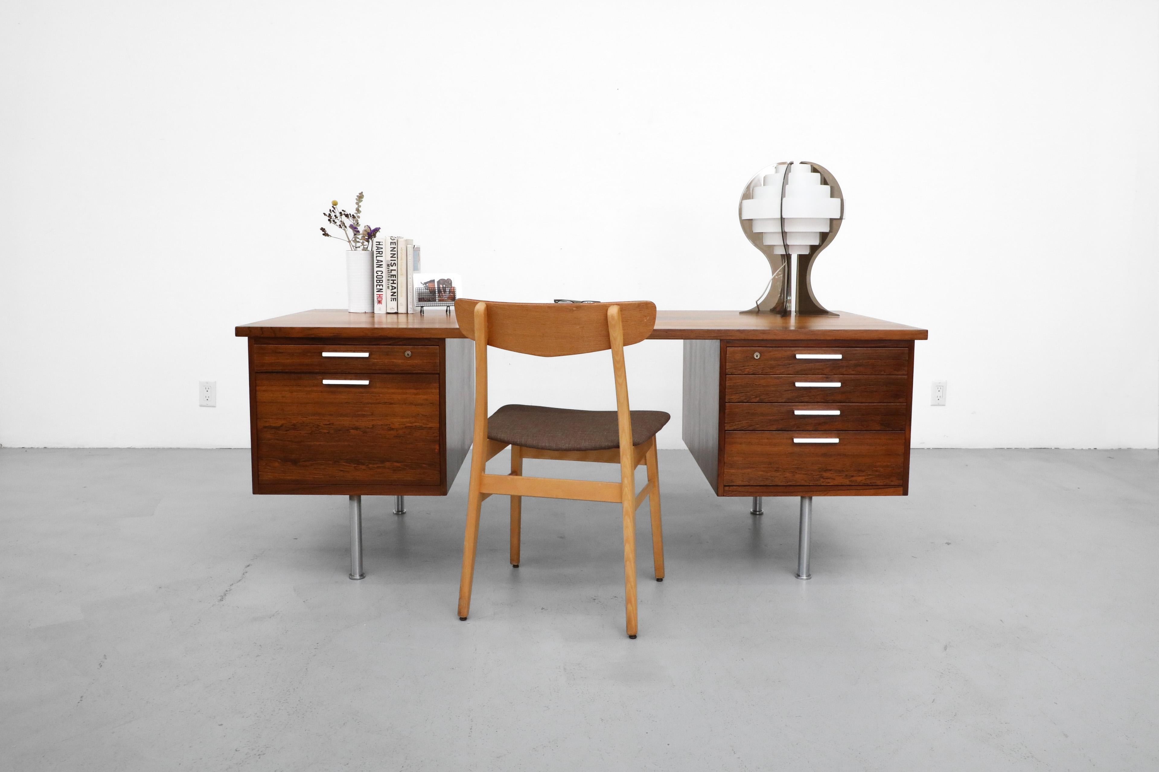 Stunning 1960s Kai Kristiansen partners desk in Rosewood for Feldballes Møbelfabrik with file drawer, bookcases on back, and cast aluminum drawer pulls. In original condition with visible wear consistent with its age and use. Shown with Borge