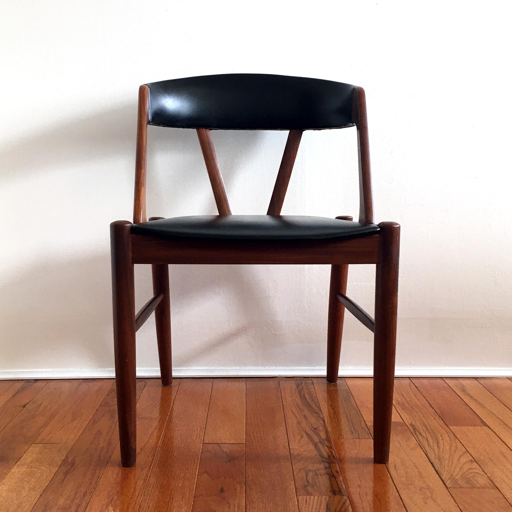 Beautiful midcentury chair in the style of Kai Kristiansen’s iconic Model 31 chair. Teak frame, with black faux leather seat and chair back.