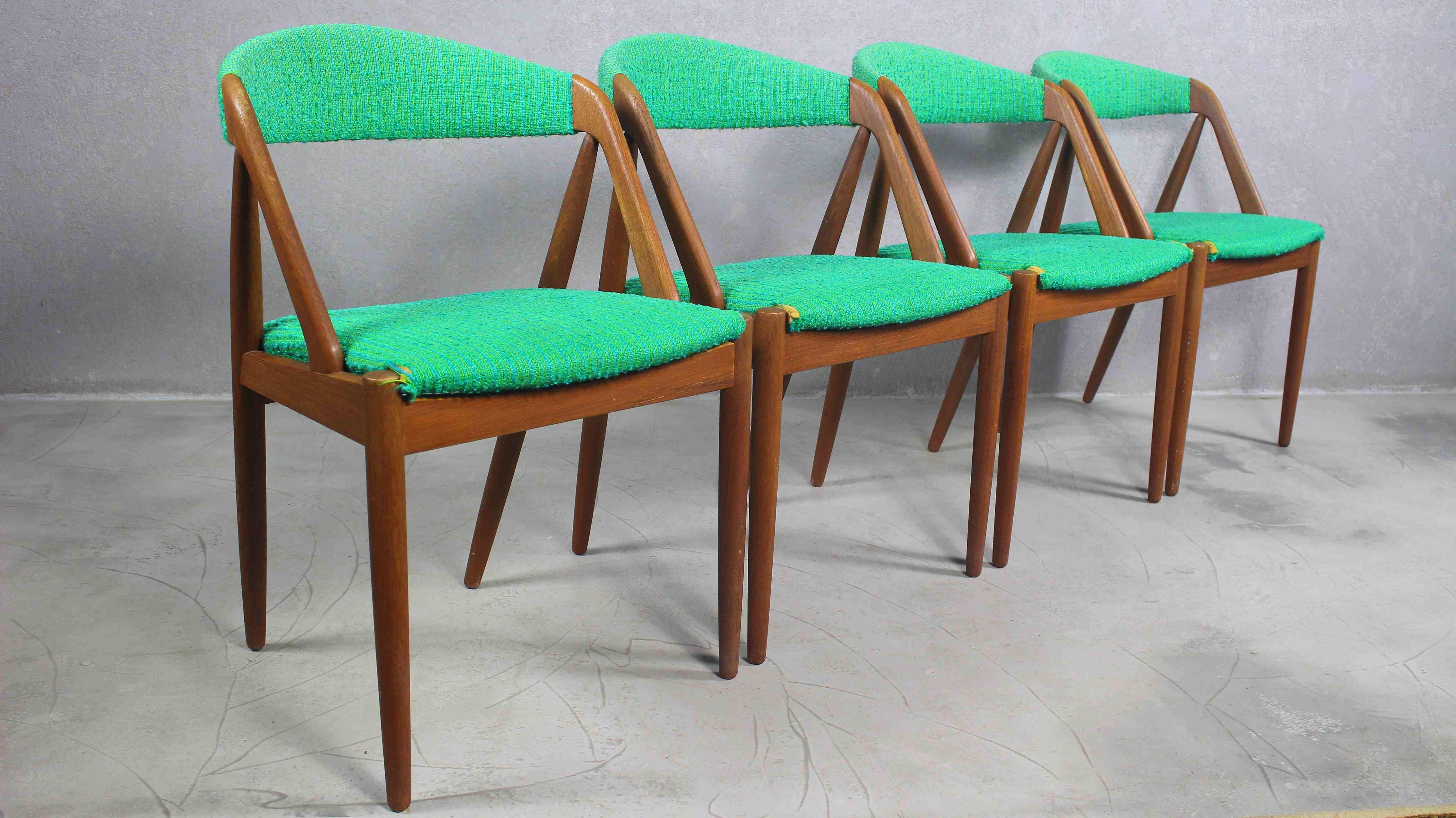 Set of four Kai Kristiansen Model 31 teak dining chairs 
Manufactured by renown furniture maker Schou Andersen
Fabric needs to replace.