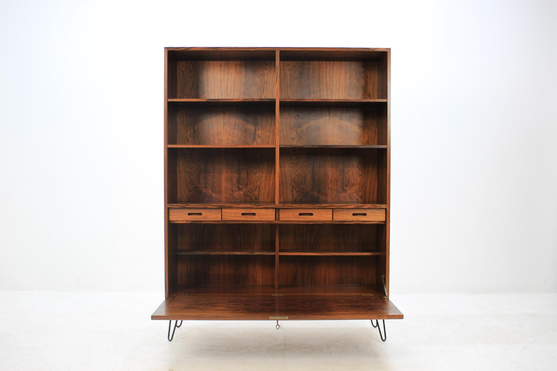 This cabinet or bookcase features one doors, shelves and four small drawers. The hairpin iron legs were added afterwards. This item was carefully refurbished.