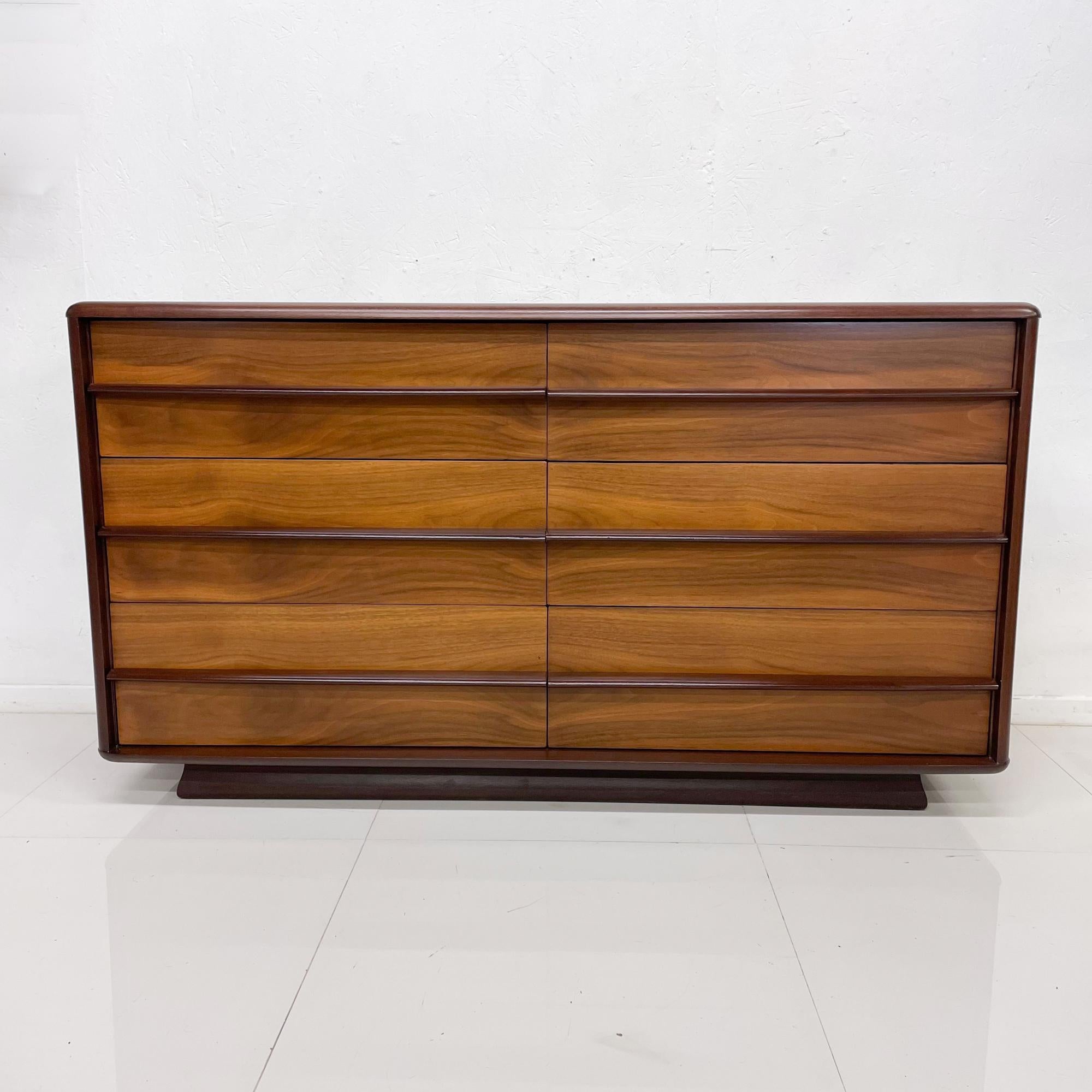 Dresser
Mid-Century Modern double dresser by Kent Coffey, line is Arcadia. USA 1960s.
Walnut wood with sculptural wood handles. Double tone walnut wood. 
Measures: 32 H x 58 W x 19 D drawer 26 x 14.5 d x 7.5 H
Preowned vintage condition