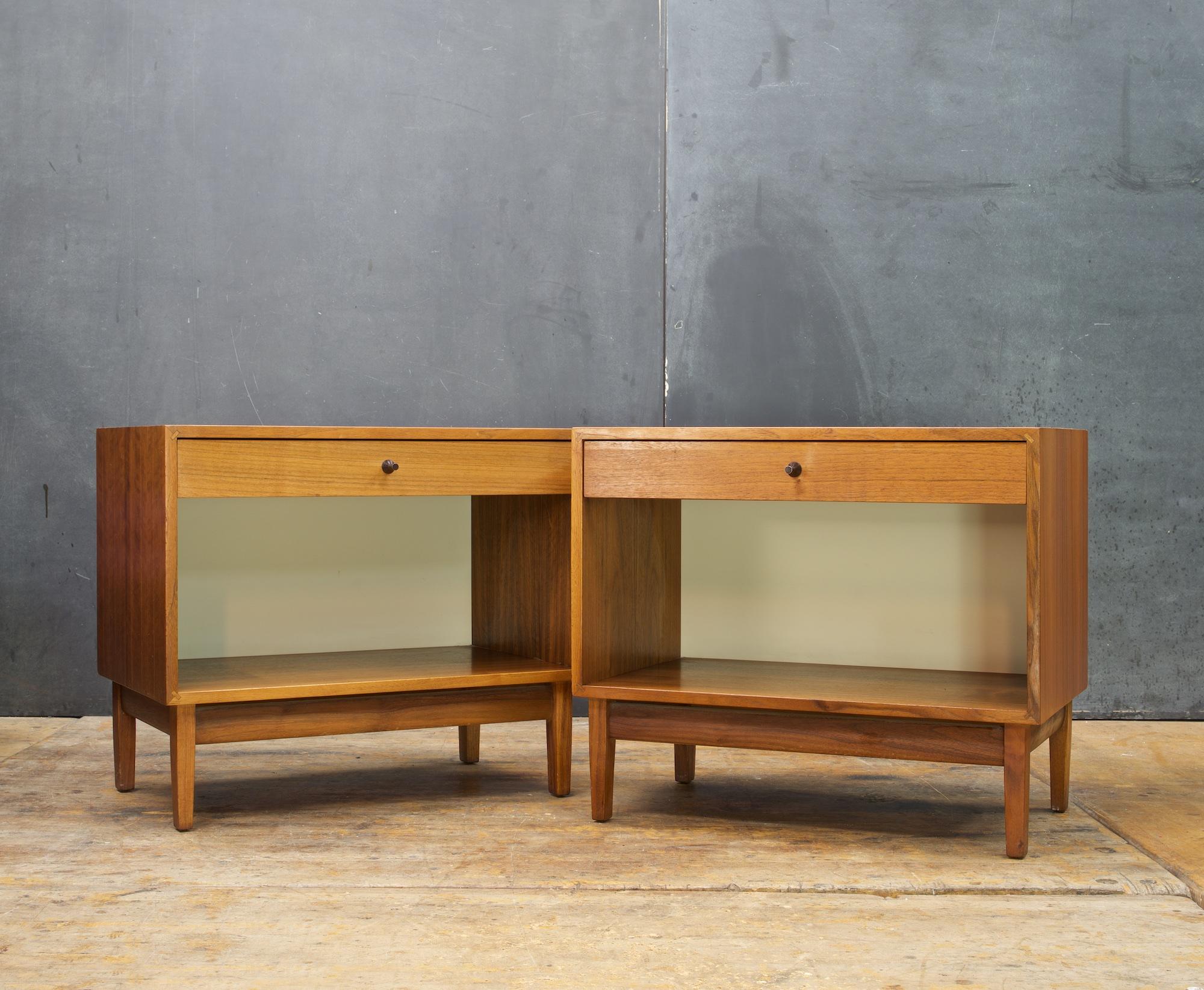 Matching Pair of oiled walnut nightstands designed by Kipp Stewart for Calvin Furniture's American Design Foundation line. Rare design, with wonderful a nice White interior back surface. 

One top has a dark area, stained very dark.

Measures:
W: 24
