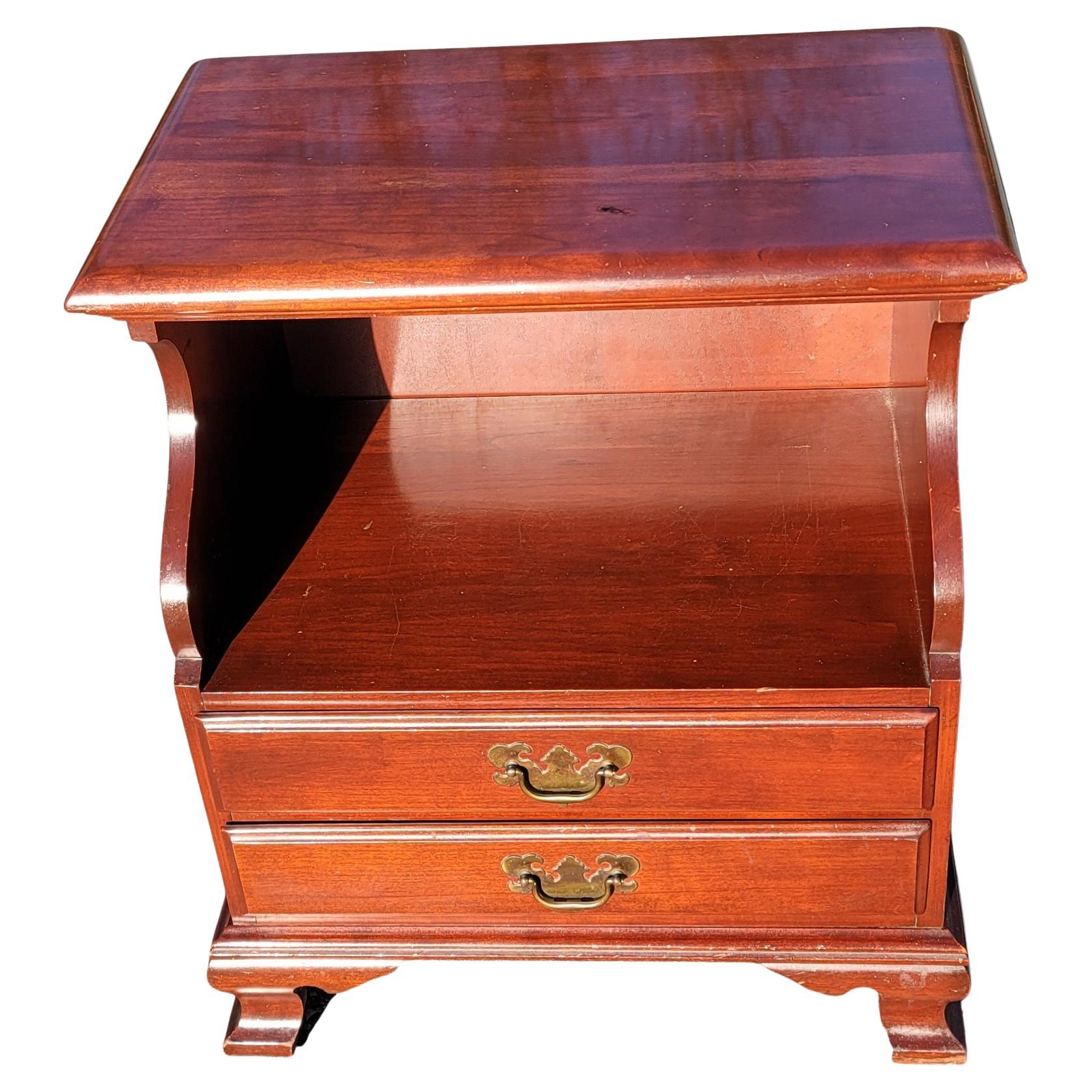 1960s Kling Factories' Solid Genuine Cherry Chippendale tiered two-drawer bedside table dovetail joints drawers perfectly functioning. Half bull nose top edge cut on the front and sides.
Clean vintage with wear consistent with age and use.