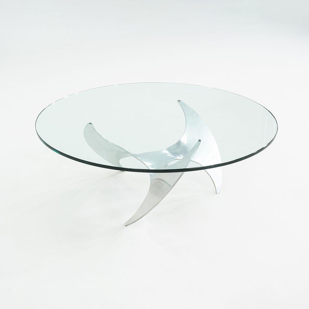 This is a Modernist 'Propeller' Aluminum and Glass Coffee Table, designed by Knut Hesterberg for Ronald Schmitt in Germany in the 1960s. The base of the table is in the shape of a propeller, constructed of polished aluminum. The thick glass top is